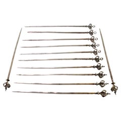 Set of twelve silver florets with openwork crown-shaped handles