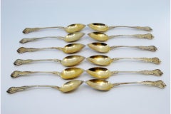 Set of twelve silver-gilt teaspoons with spouts on the shells and raised handles
