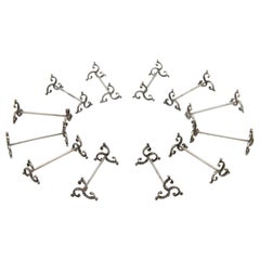 Set of twelve silver knife rests