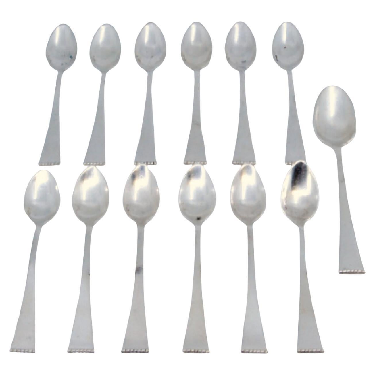 Set of twelve silver teaspoons and sugar scoops with pearl handles For Sale