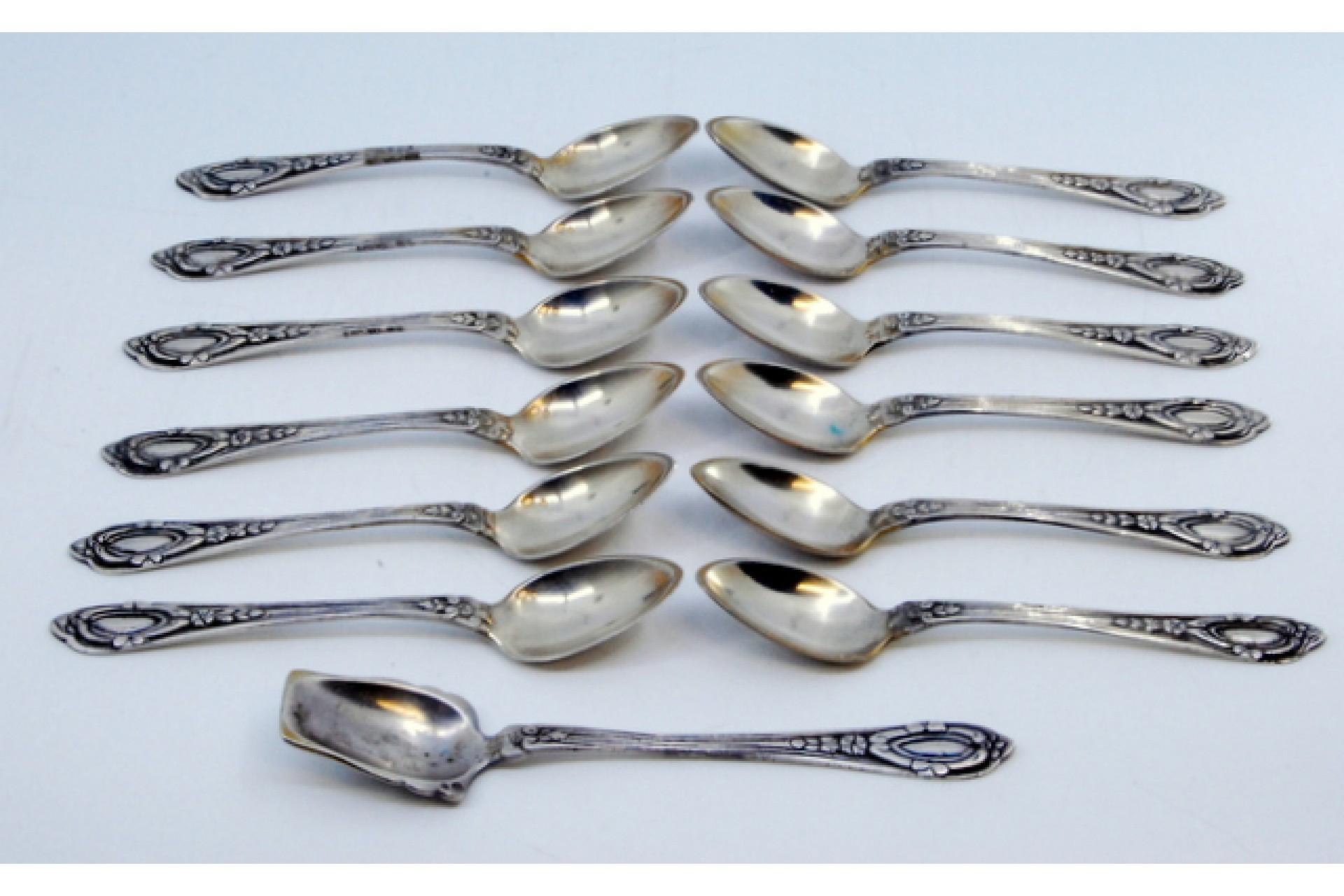Description: Set of twelve teaspoons and sugar shovel in silver with reliefs on the handles. Metal: Silver. Origin: Portuguese. Brand: javali II Title. Weight: 259.64 grams (Set of twelve spoons and shovel). Dimensions: Shovel - 14x2.6cm Spoon -