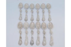 Set of twelve silver teaspoons embossed w/ tree trunks, leaves & beaded shells