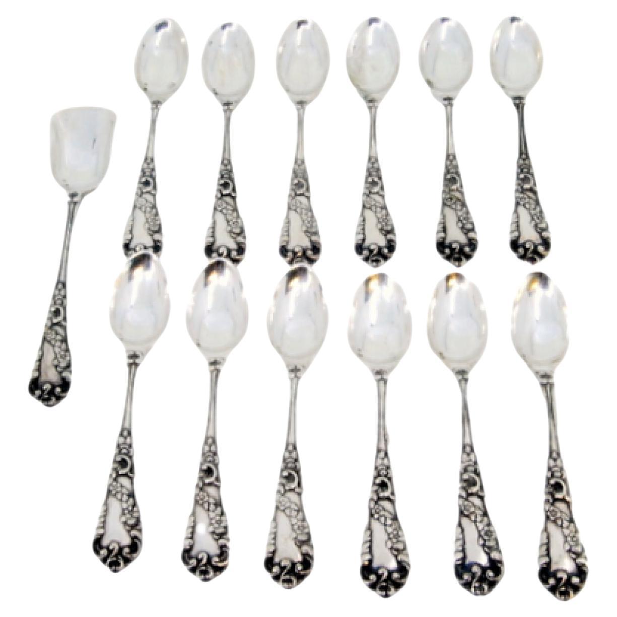Set of twelve silver teaspoons
sugar shovel w/ floral reliefs on the handles