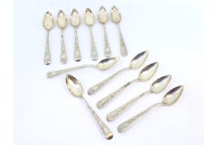 Set of twelve silver teaspoons with floral motifs engraved on the handles