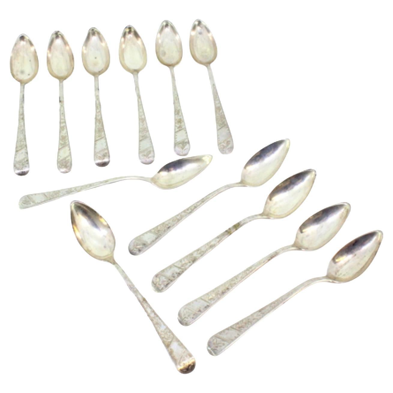 Set of twelve silver teaspoons with floral motifs engraved on the handles
