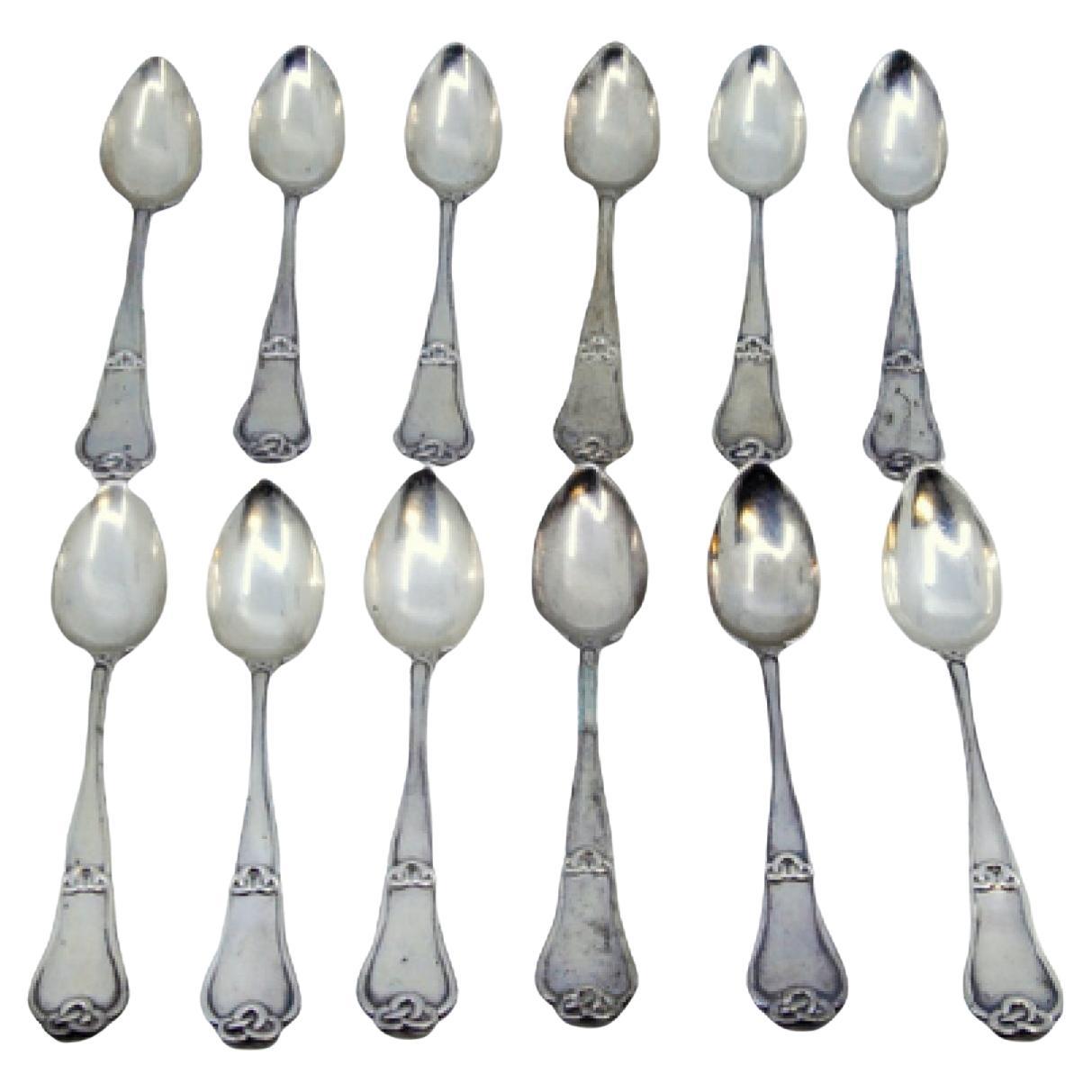 Set of twelve silver teaspoons with reliefs and grooves on the handles