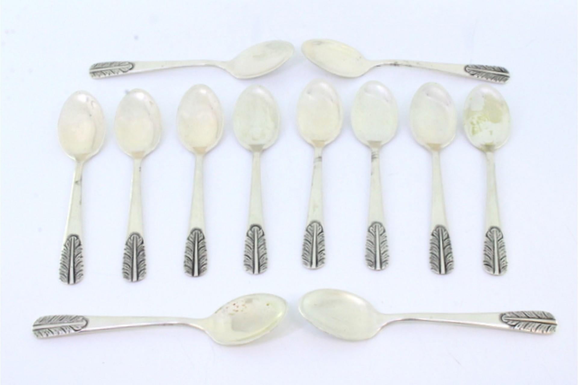 Description: Set of twelve silver teaspoons with reliefs on the . Metal: Silver. Origin: Portuguese. Brand: Eagle Head. Weight: 263.16 grams (Set of twelve spoons). Dimensions: 12cmx2.6cm. Content: 833/1000. Assay Mark: Yes, between 1938 and 1984.
