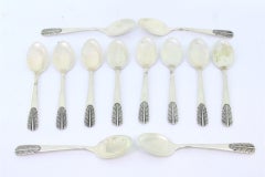 Set of twelve silver teaspoons with reliefs on the handles