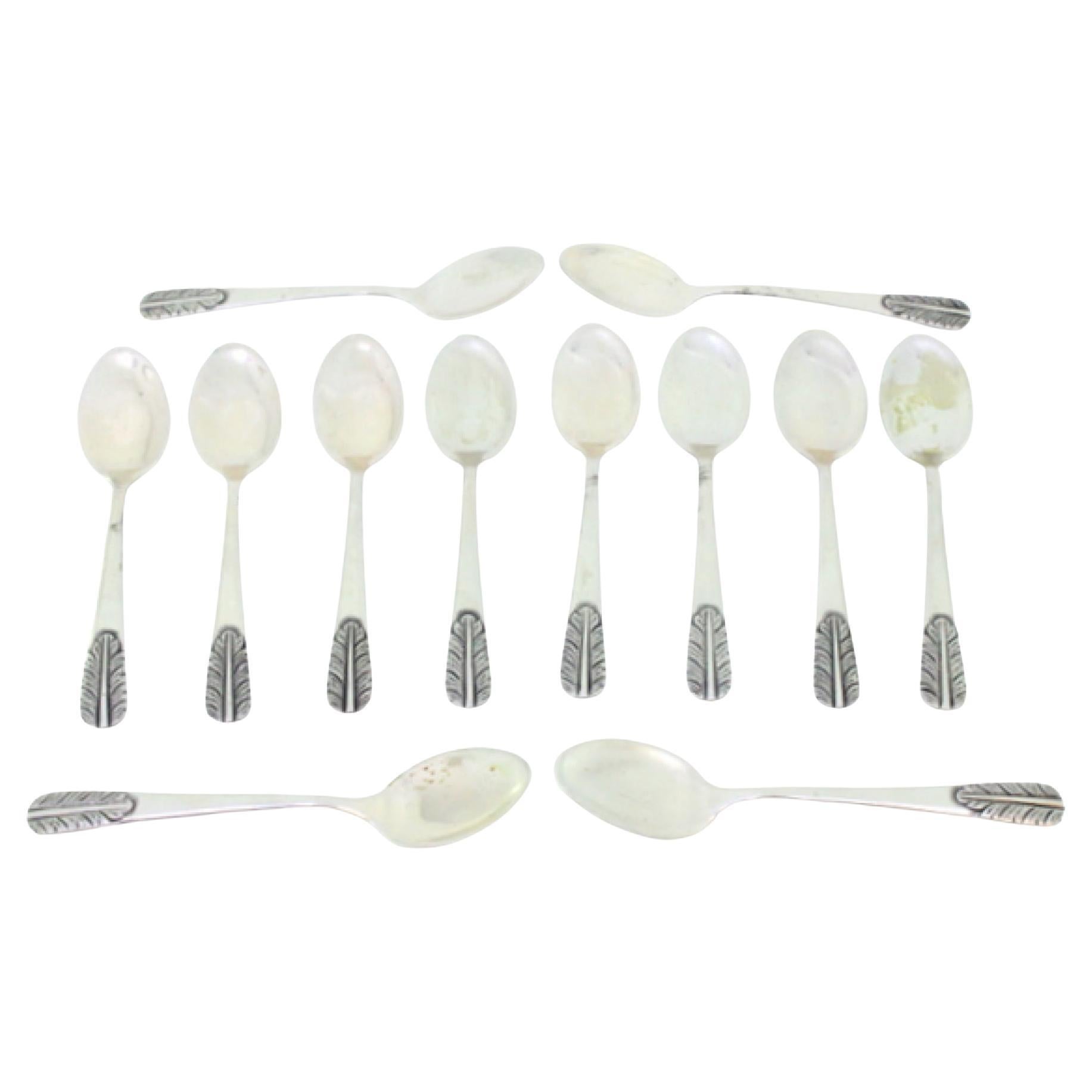 Set of twelve silver teaspoons with reliefs on the handles