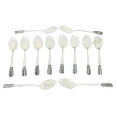Set of twelve silver teaspoons with reliefs on the handles