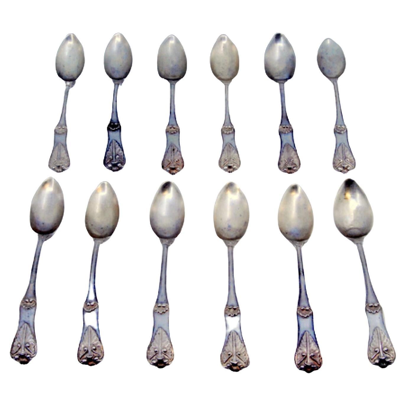Set of twelve silver teaspoons with shells and raised grooves on the handles