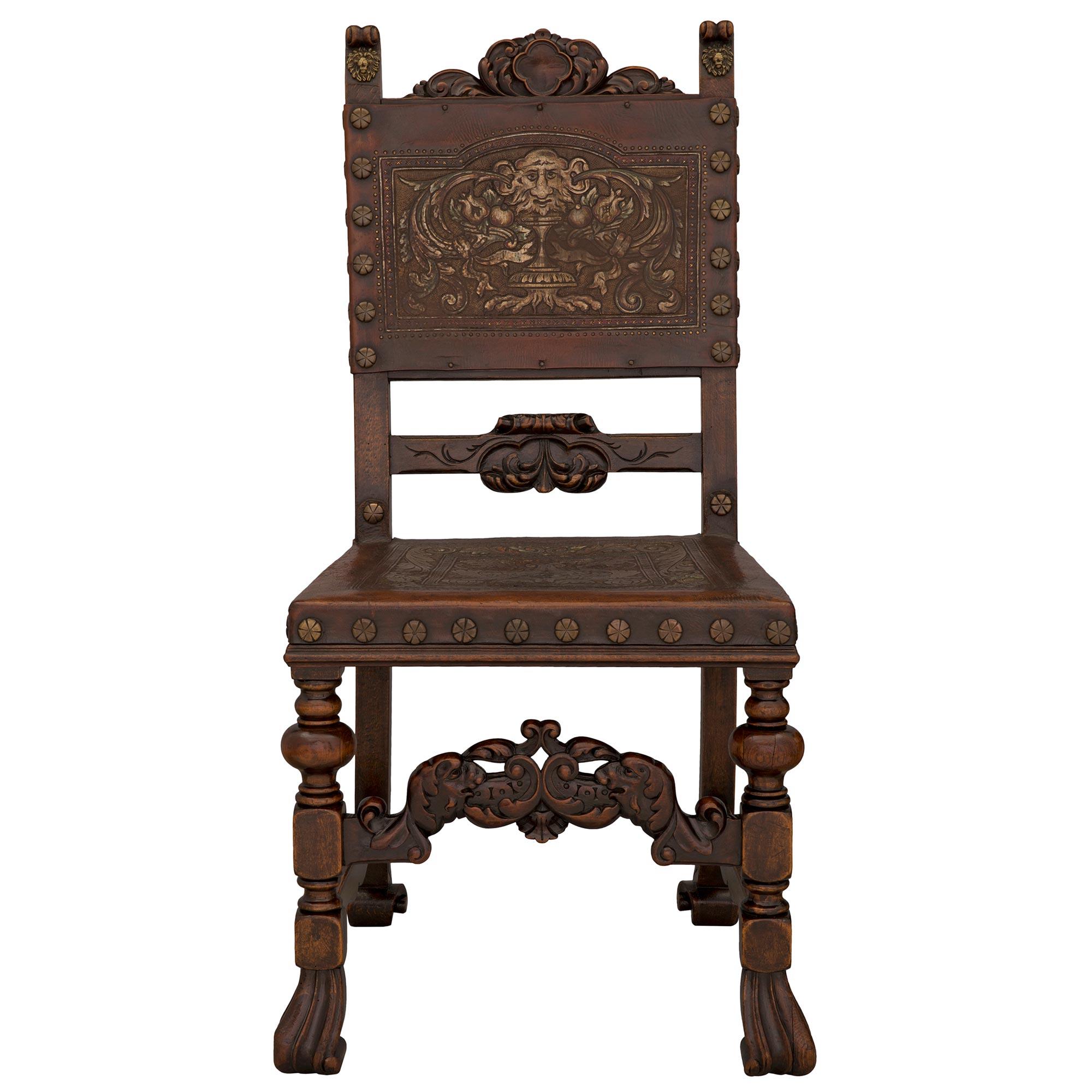 A striking and most decorative complete set of twelve Spanish 19th century walnut, pressed leather, and bronze dining chairs. Each chair is raised by beautiful most unique scrolled feet below block reserves and turned legs. Each leg is connected by