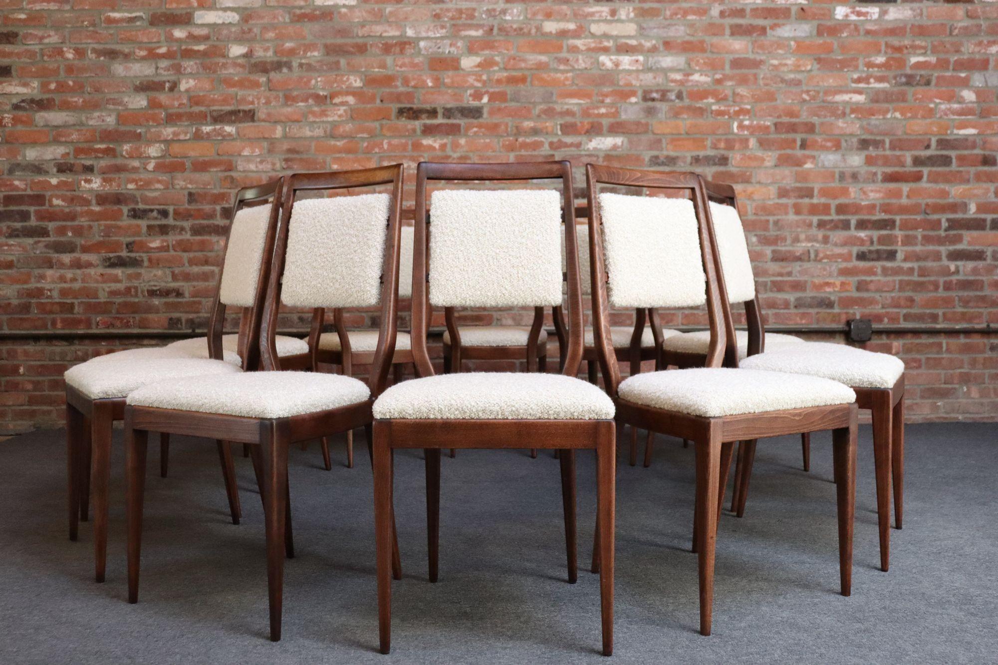 Set of twelve Vittorio Dassi dining chairs (ca. 1950s, Italy). Composed of deeply sculpted Italian walnut frames with tapered legs, the back two angled slightly.
Though Dassi designed a few versions of this dining chair, the signature characteristic