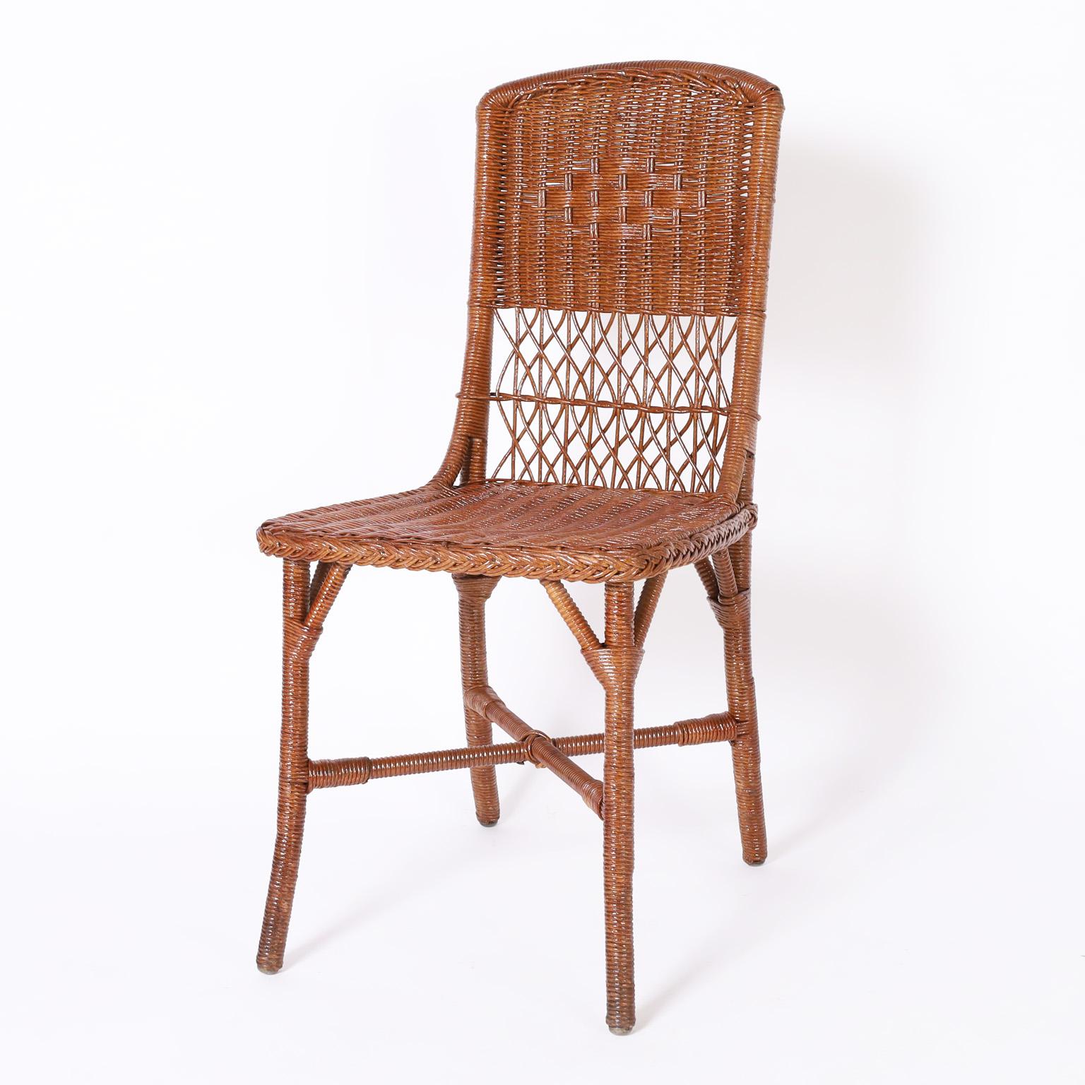 Standout set of twelve wicker side chairs in remarkable condition with multiple weaving techniques, crafted with brackets and cross stretchers for durability. Originally called fiber furniture in the 1937 catalog signed Sheboygan Furniture Co. on