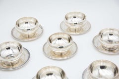 Set of twelve washbasins in smooth silver with beaded reliefs on the bases