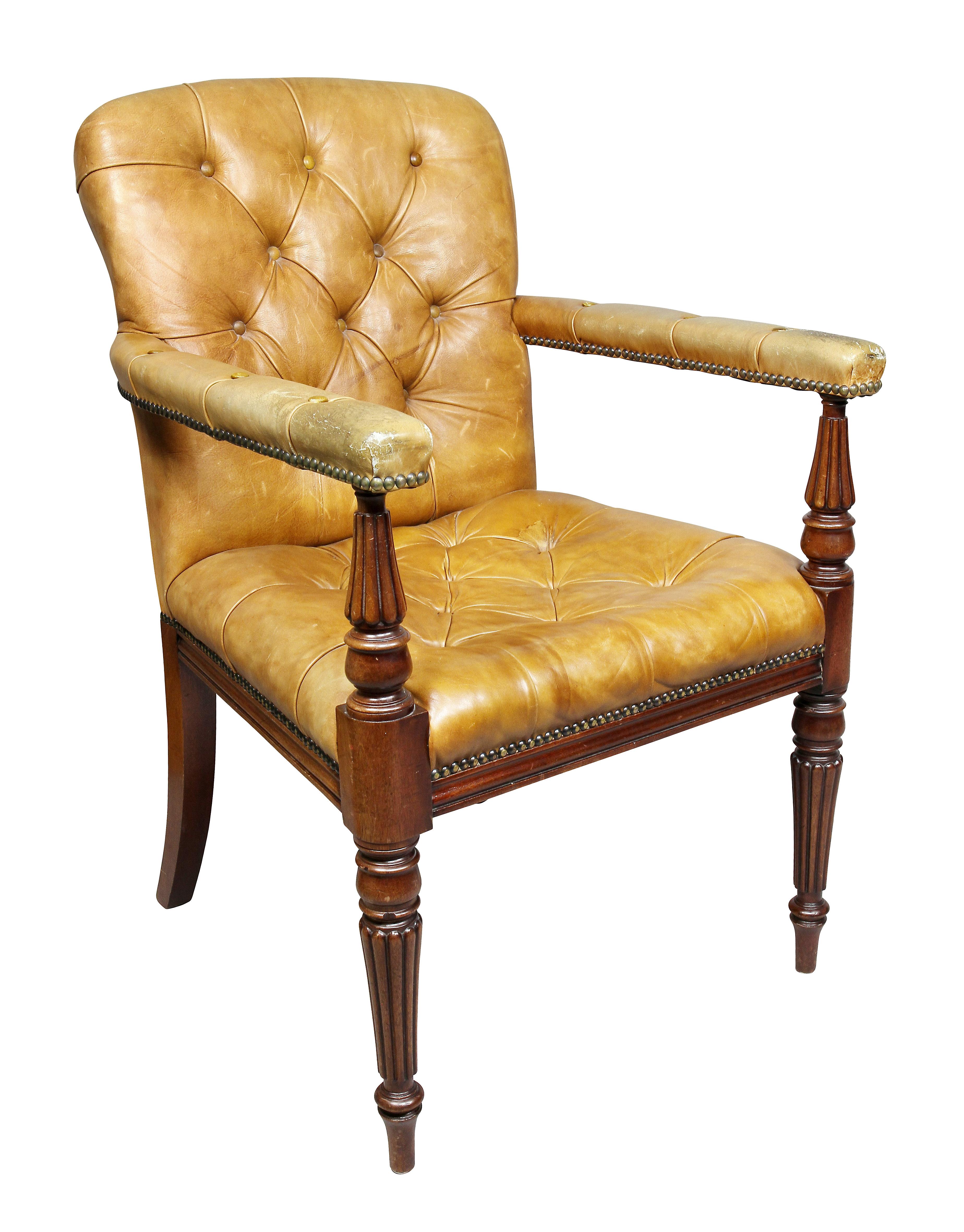 Comprising eighteen side and two armchairs, each with tufted brown leather upholstery raised on tapered circular tapered reeded legs.