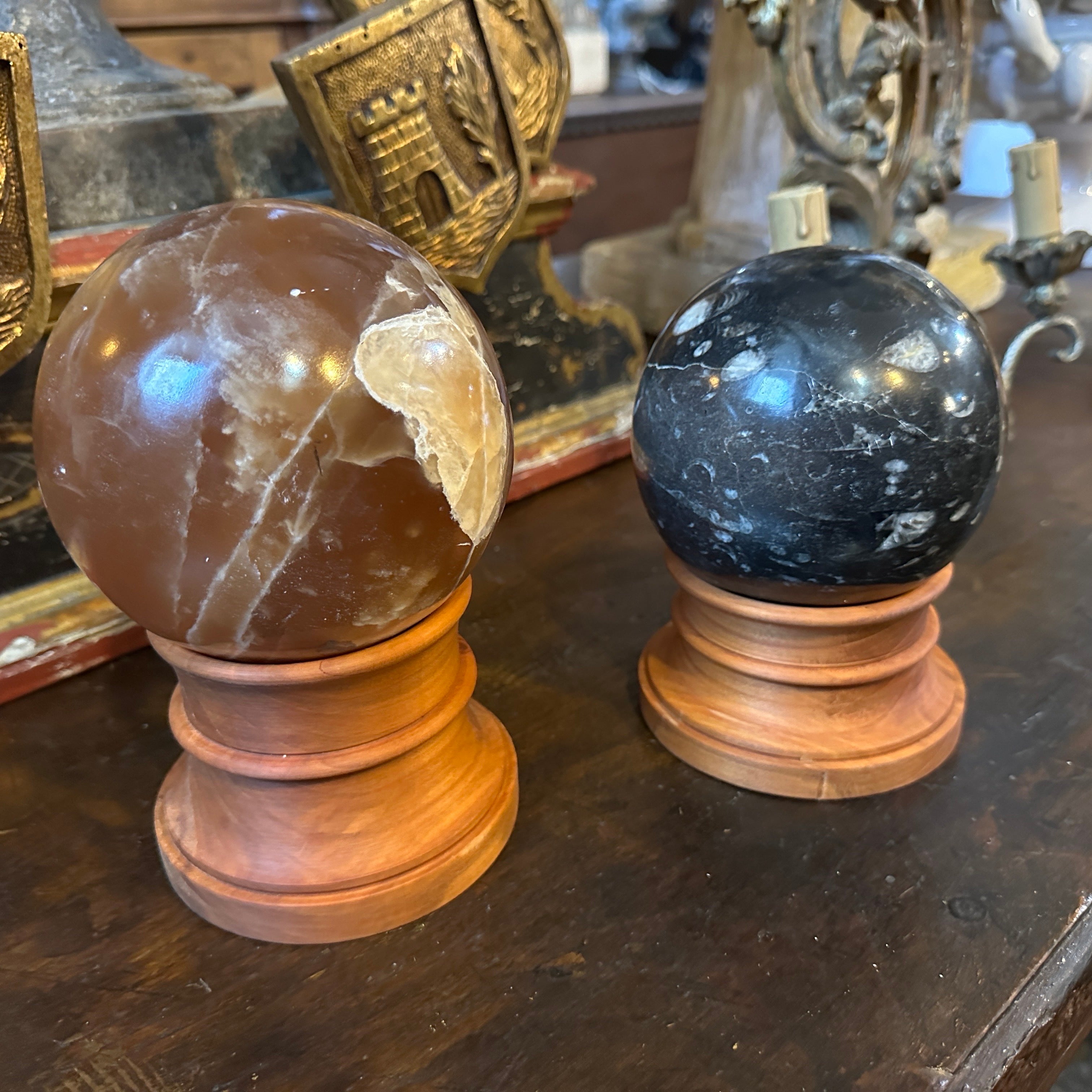 Each sphere was crafted from high-quality italian marble, a material favored in Art Deco design for its luxurious appeal and durability. The marble exhibits classic Italian marble characteristics providing a bold contrast to the cherry wood