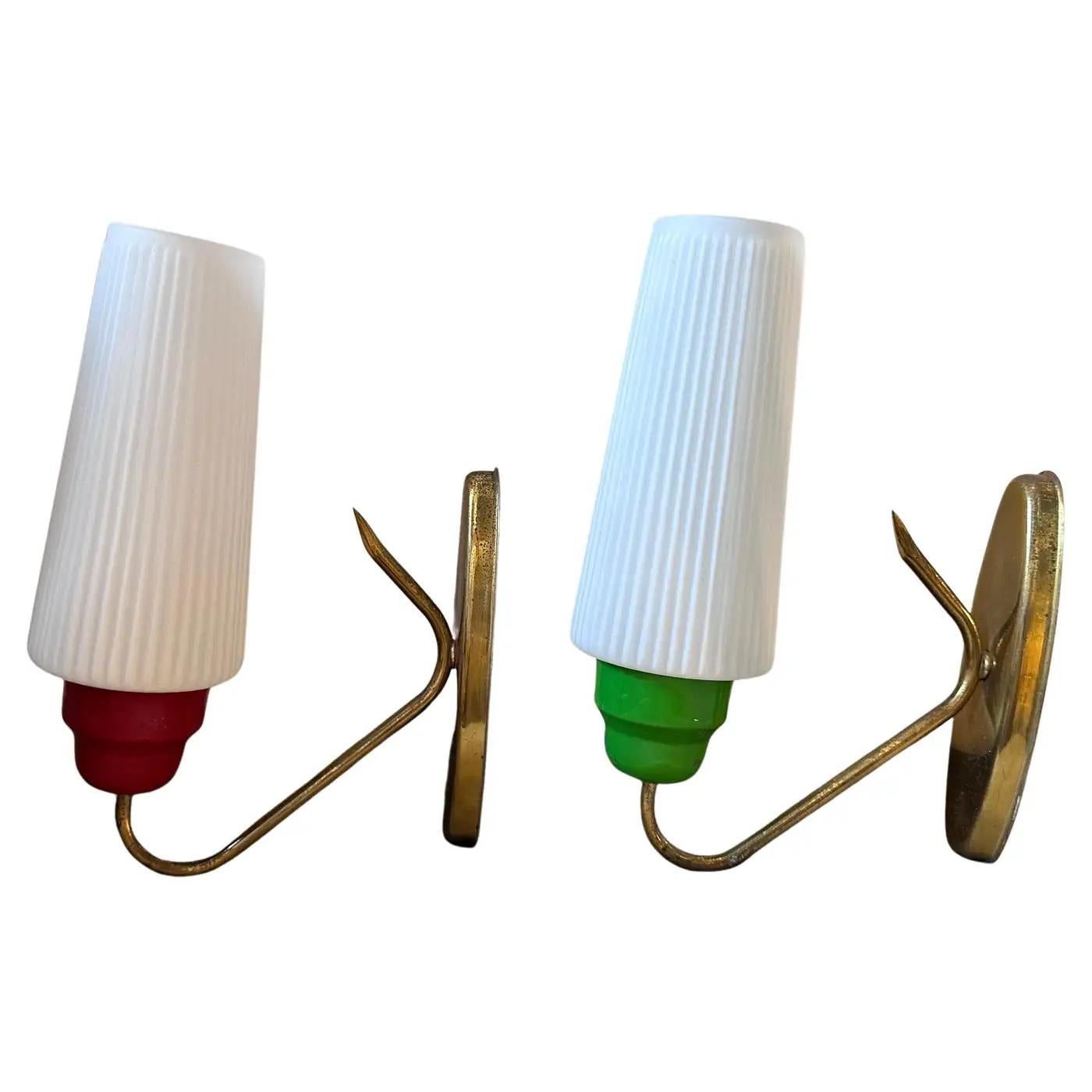 A pair of Mid-Century Modern brass, green and red painted aluminum and white glass wall sconces designed and manufactured in Italy in the fabulous Sixties in the manner of Stilnovo, italian famous manufacturer, they are in working order, they only