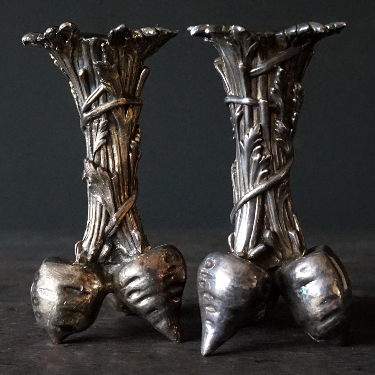 Vintage 1960s Christofle silver plated bronze radish bud vases also know as soliflore or solifleur as you could put one flower in them. But they also could be used as small candle holders.  
I'm not sure if they are little carrots, beets, turnips or