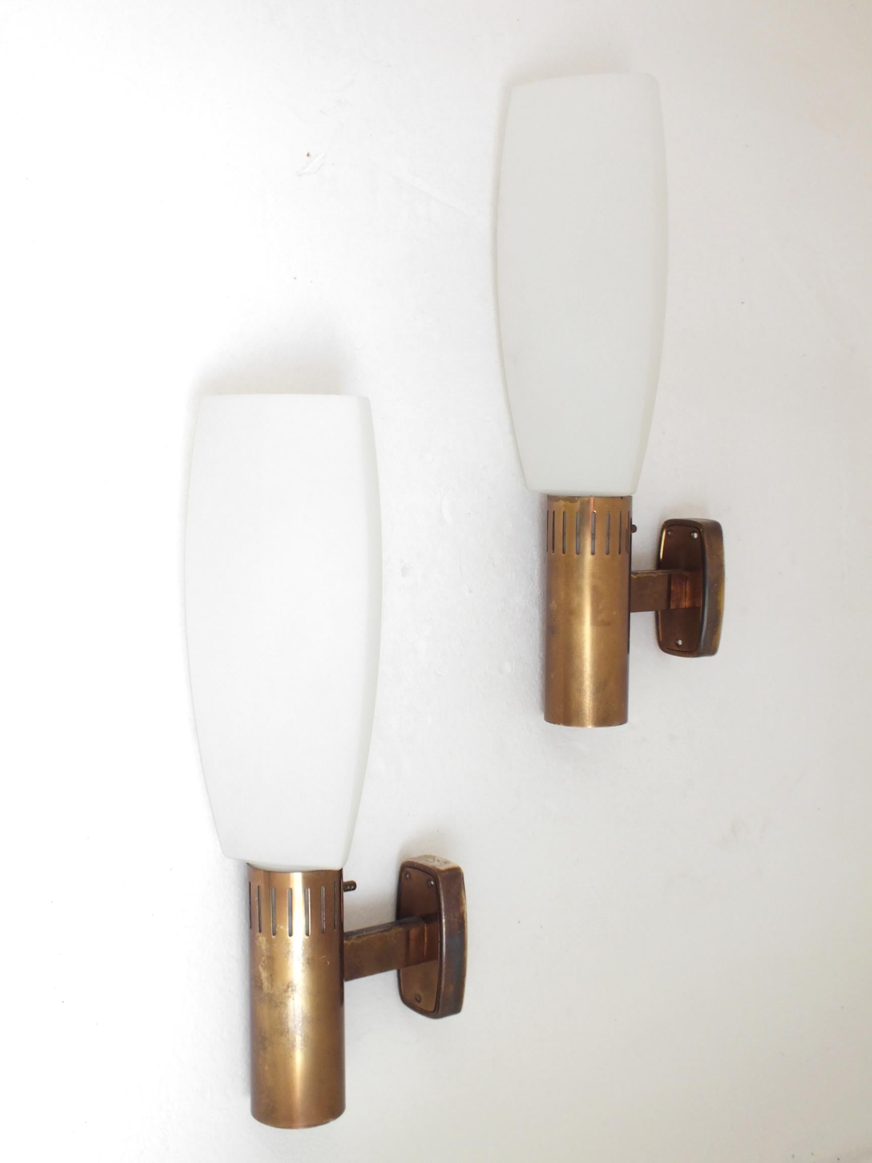 Stilnovo Italy design Bruno Gatta years 60 Italy production set of two wall lamps in brass glass.

 Good vintage condition, no defect.

 Measure: Hight 18 inches x deep 8 inches.