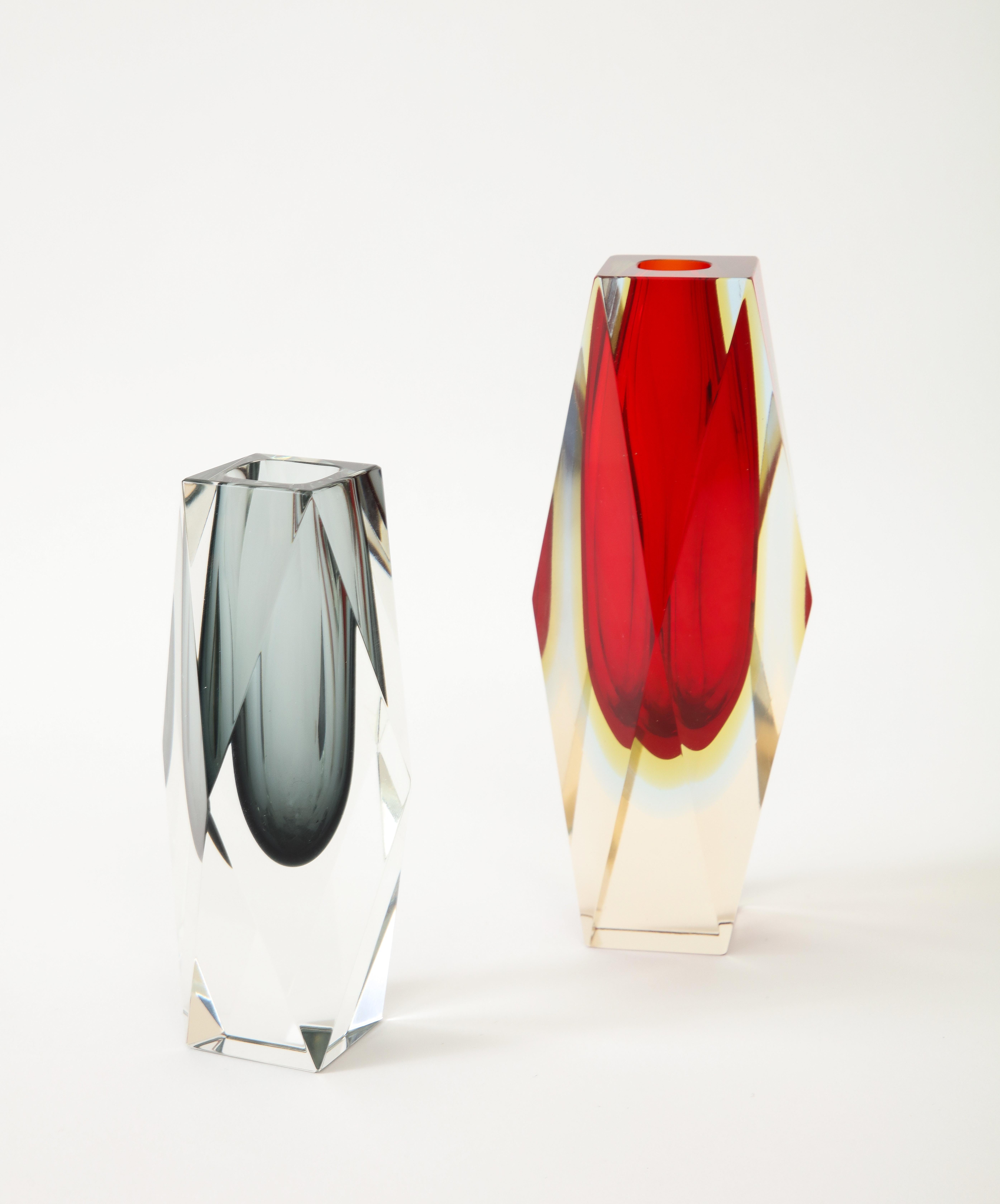 Set of two 1970's  Murano glass vases designed by Flavio Poli.
The vases are made in the Sommerso technique and have a wonderful block
form to them.
The Red vase is 8