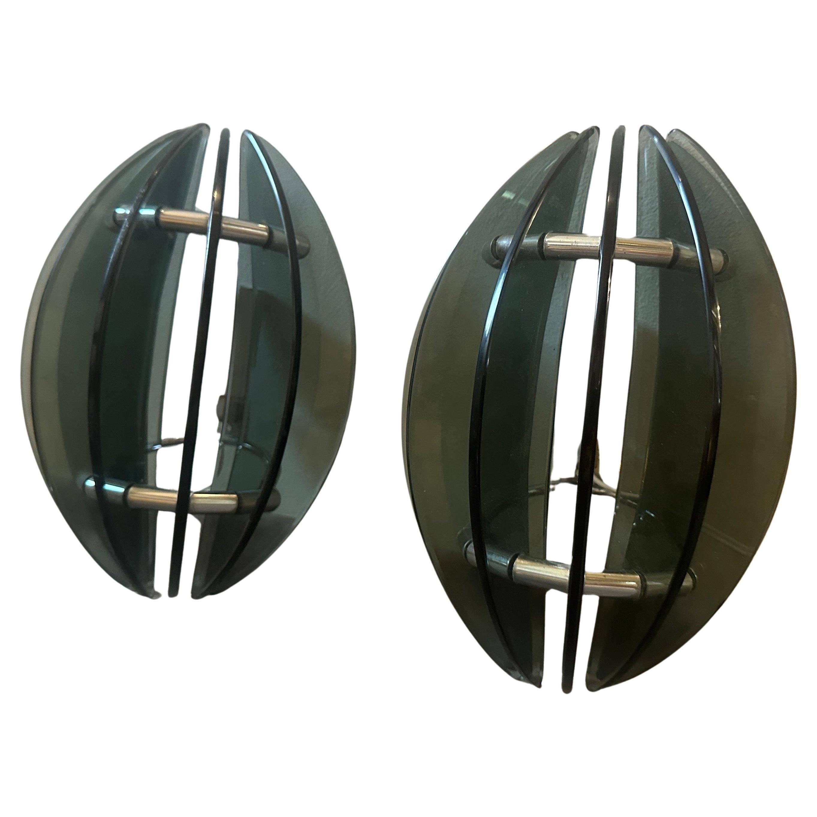 A pair of wall sconces designed and manufactured in Italy by Veca in the Space Age Era, they are in very good original condition and in working order. In the 1970s, the Space Age design movement embraced futuristic and avant-garde styles, often