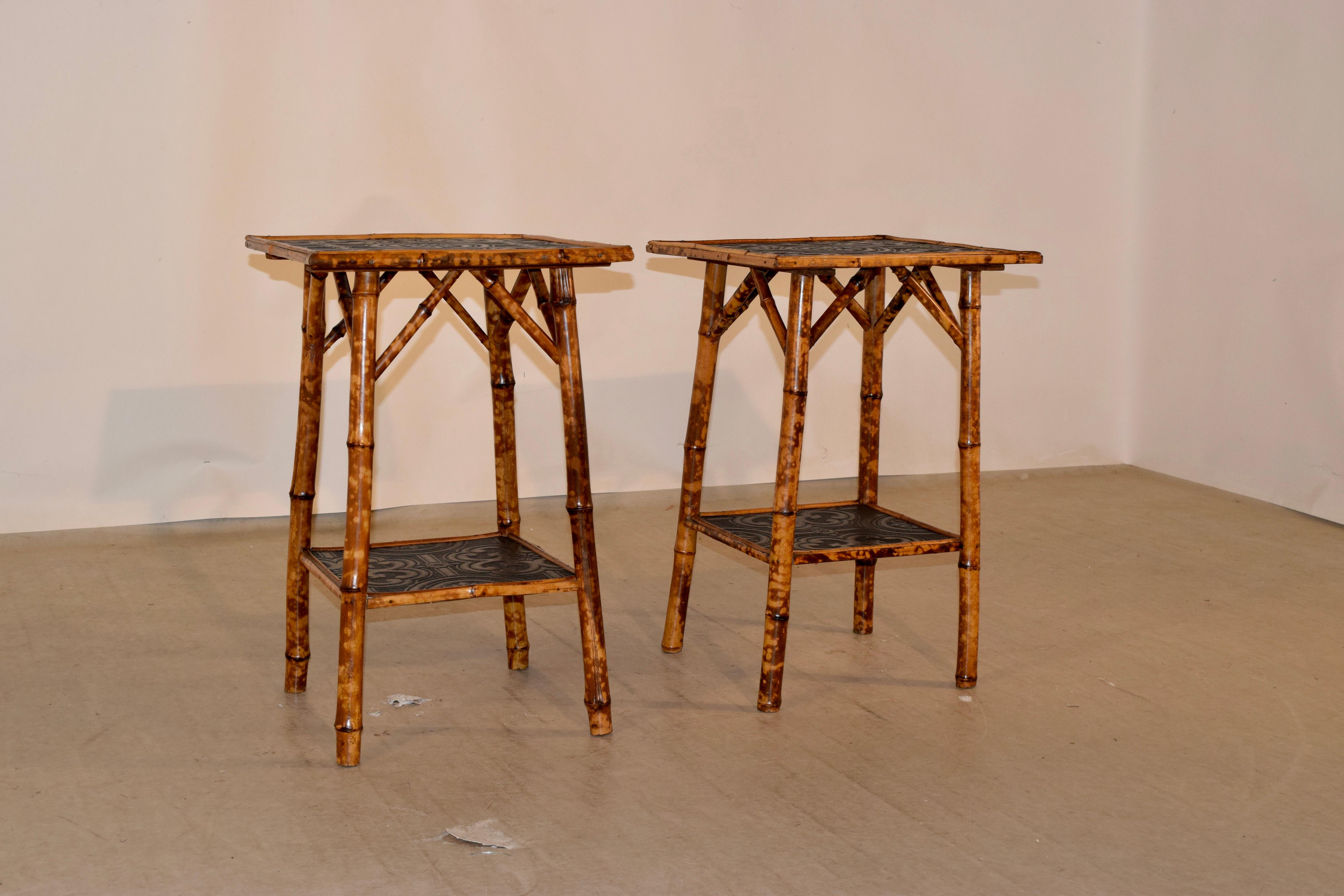 Set of two 19th century bamboo side tables from France with navy painted wallpaper on tops and lower shelves. The table is made from tortoise bamboo. The second table measures 17 W x 17.38 D x 26.63 H.