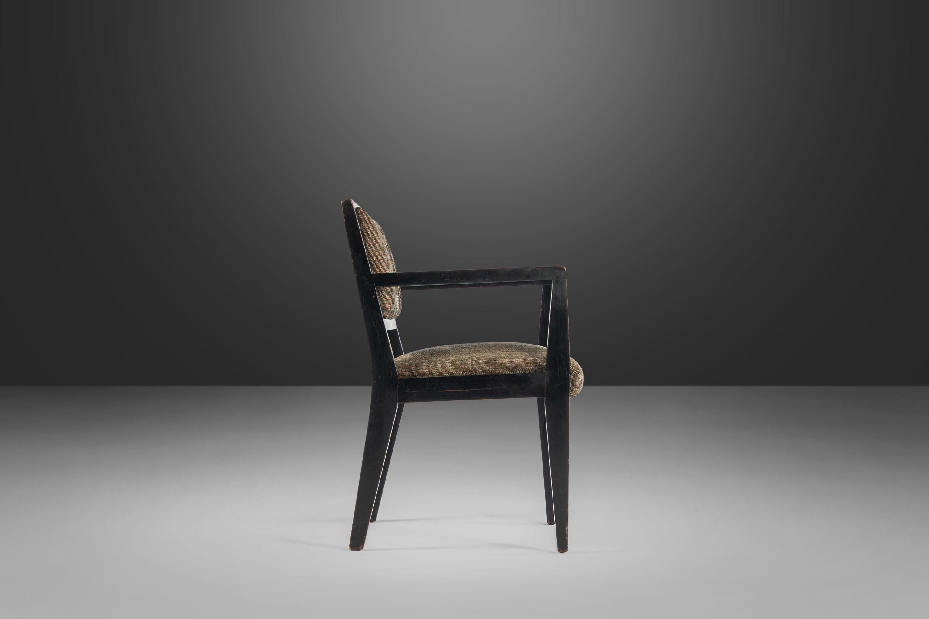 Stately and sophisticated with striking angular lines reminiscent of and often attributed to Edward Wormley for Dunbar. This set of armchairs is constructed from solid walnut and is found in its original tastefully patinaed black paint. The fabric