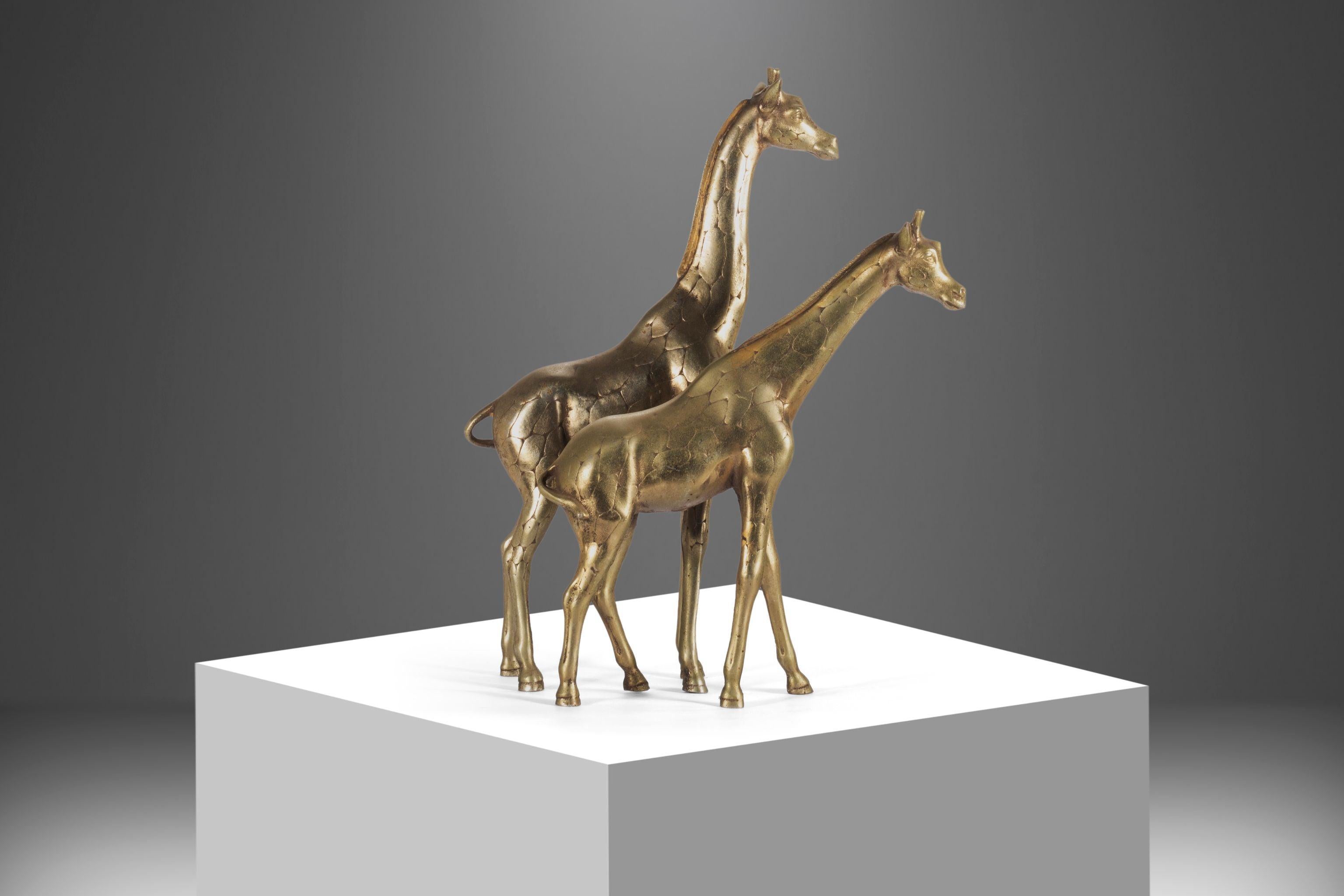For your consideration a pair of large modernist solid brass giraffe floor statues / floor sculptures. These Hollywood Regency brass animal sculptures have great details and great shape of posing. The male has a long slightly bent neck and can be
