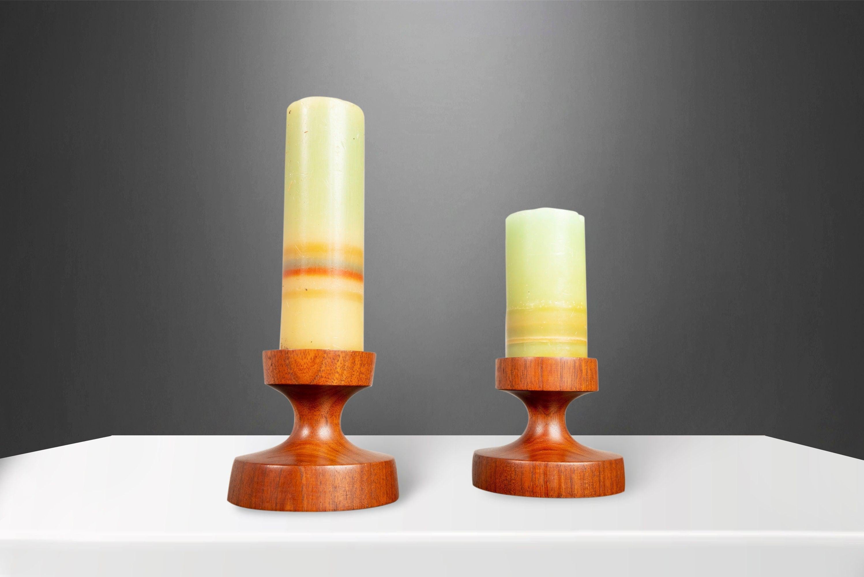 This set of Danish candlestick holders signed by Rude Osolnik are in nearly perfect original condition. Both perfectly minimal and yet statement making all at once this set, made from solid walnut slabs with exceptional old-growth woodgrains are the
