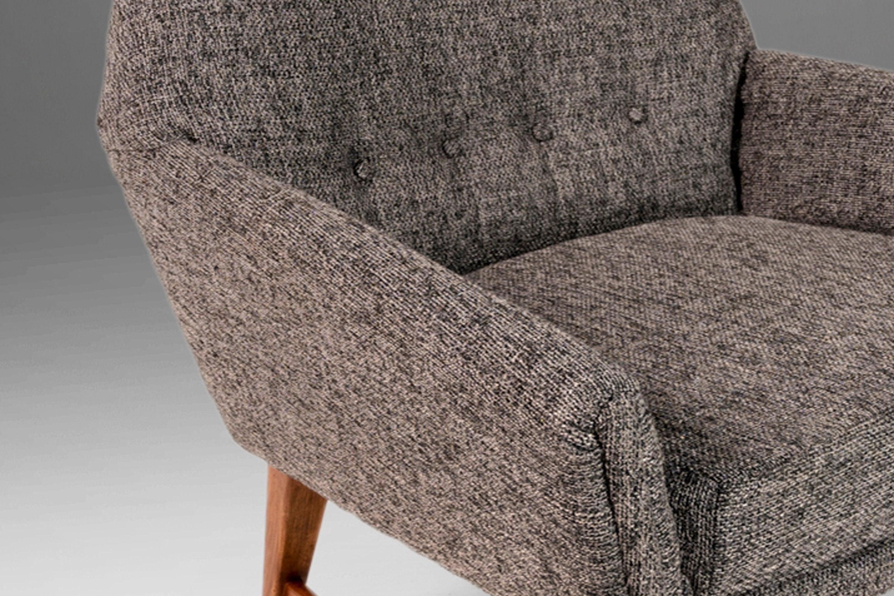 Equal parts comfort and style this extraordinary set of armchairs has recently undergone a comprehensive and transformative restoration and the results speak for themselves. Featuring new upholstery, in a fabulous charcoal tweed, set atop a set of