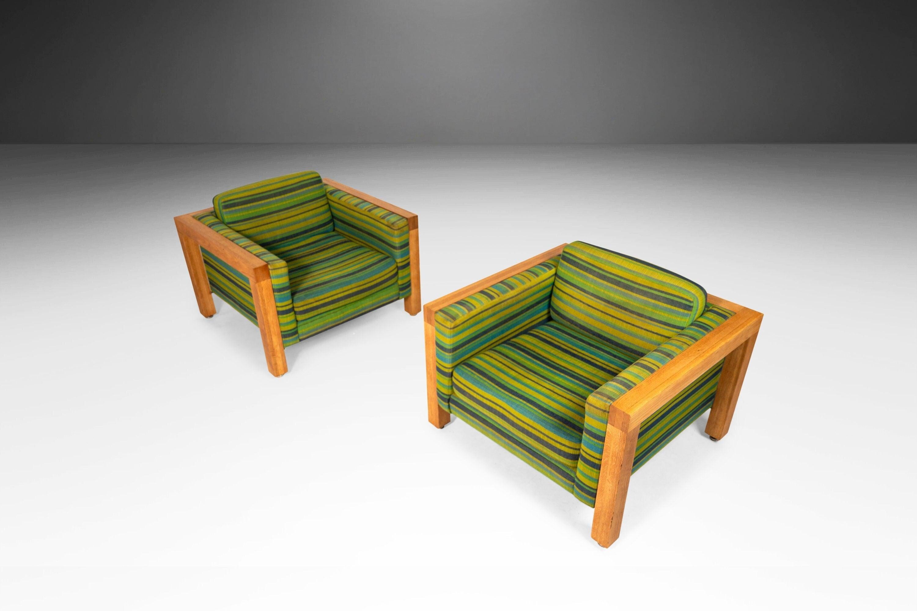 Substantial and striking. This pair of cube chairs are set on oak baes. The chairs are found in their original striped fabric which is in good vintage condition. If the fabric is not most suitable for your design project. Circa