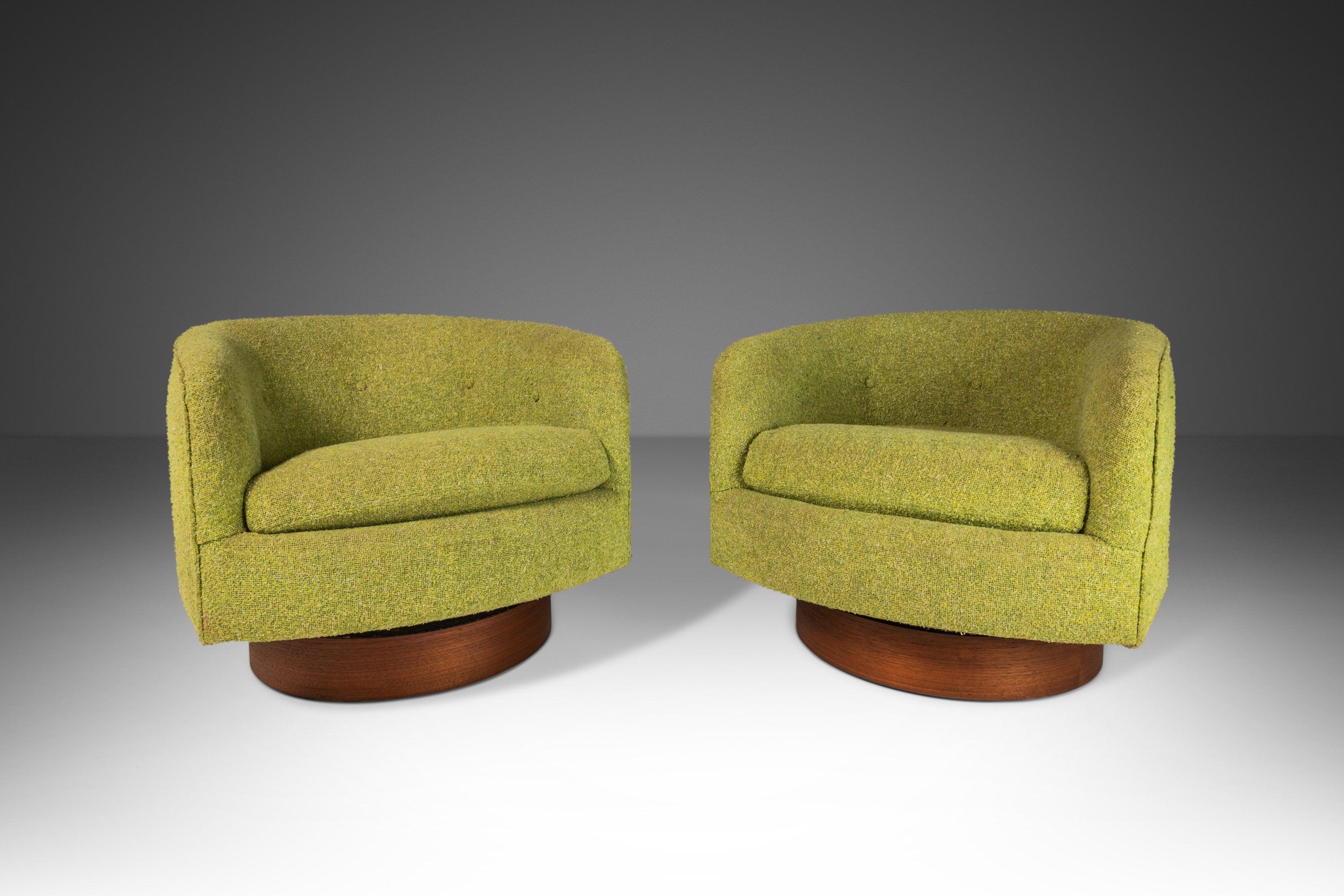 Handsome pair of swivel chairs by Milo Baughman. In stunning original lime-green tweed upholstery and resting on a medium walnut base. Extremely comfortable and classic design. Perfect in a home, office or studio setting against a multitude of
