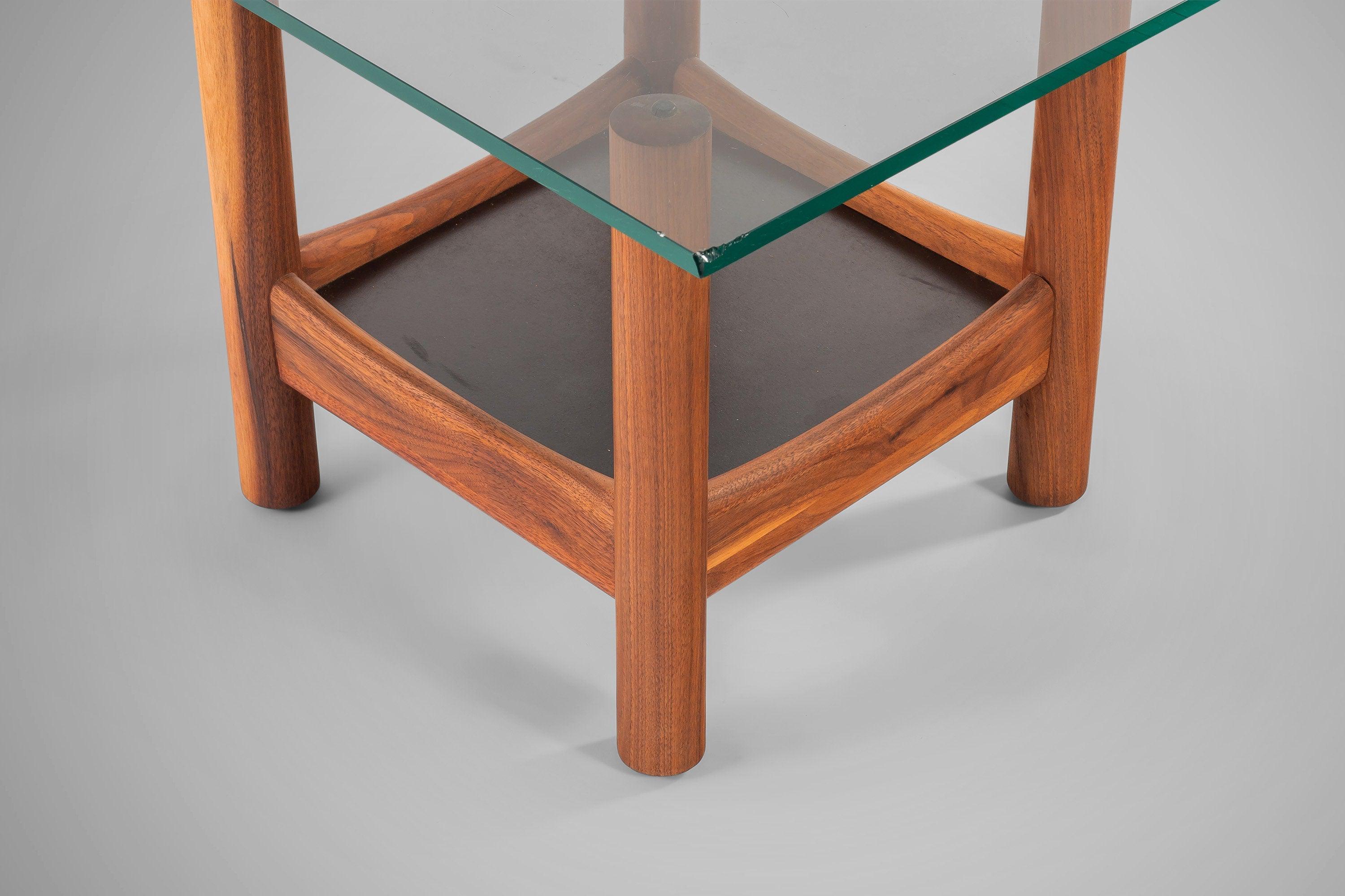 Solid, rich-grained doweled end tables with heavy glass tops. With shelves underneath the glass, these tables can be used for a display as well as storage. These tables are as strong as they are beautiful and can support a great deal of weight.
 