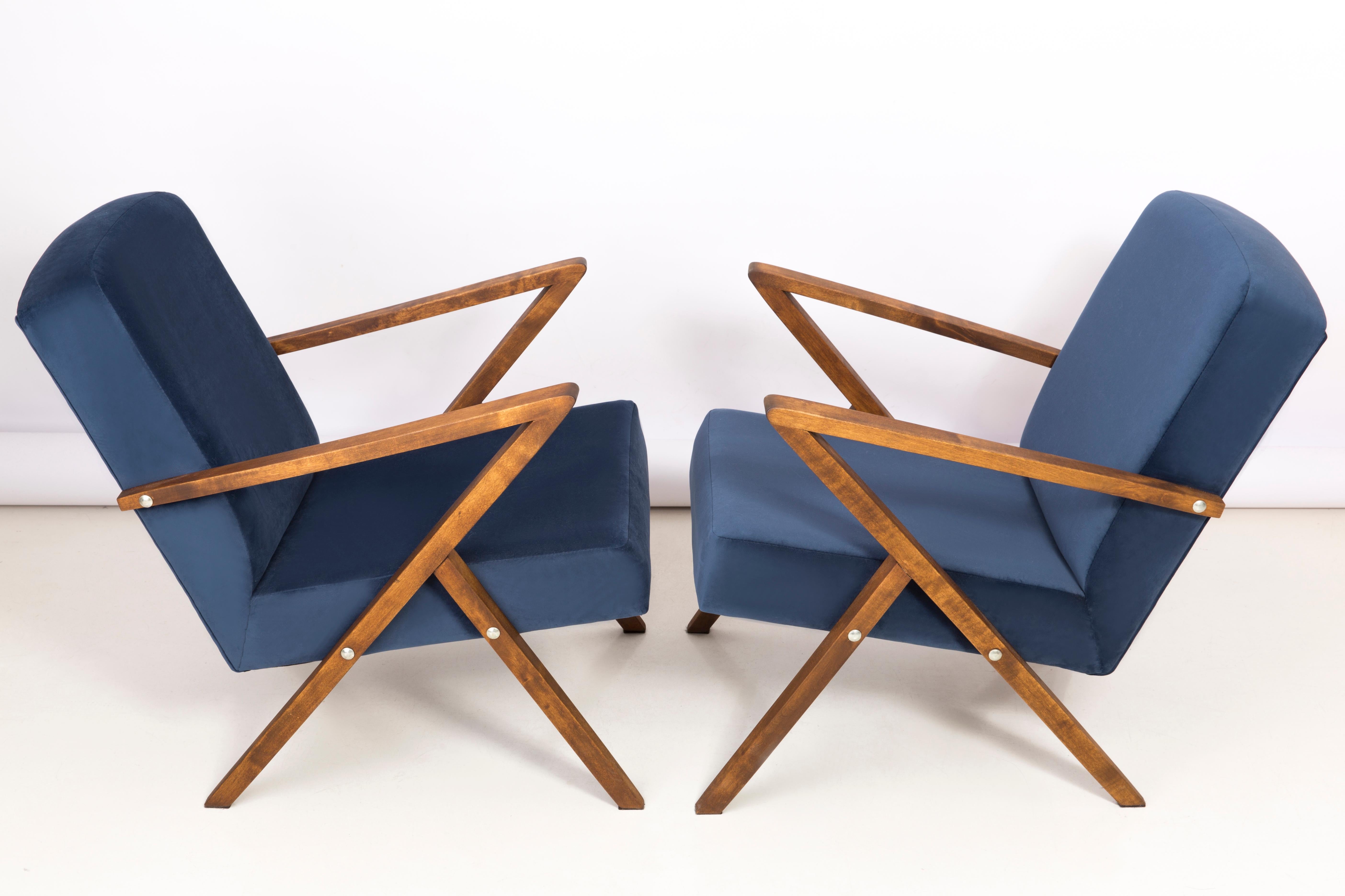 A pair of armchairs manufactured at the Bydgoszcz Renewal Cooperative in the 1970s. The armchairs are after a comprehensive renovation of carpentry and upholstery. The wood has been cleaned, cavities completed, painted with dark walnut stain,