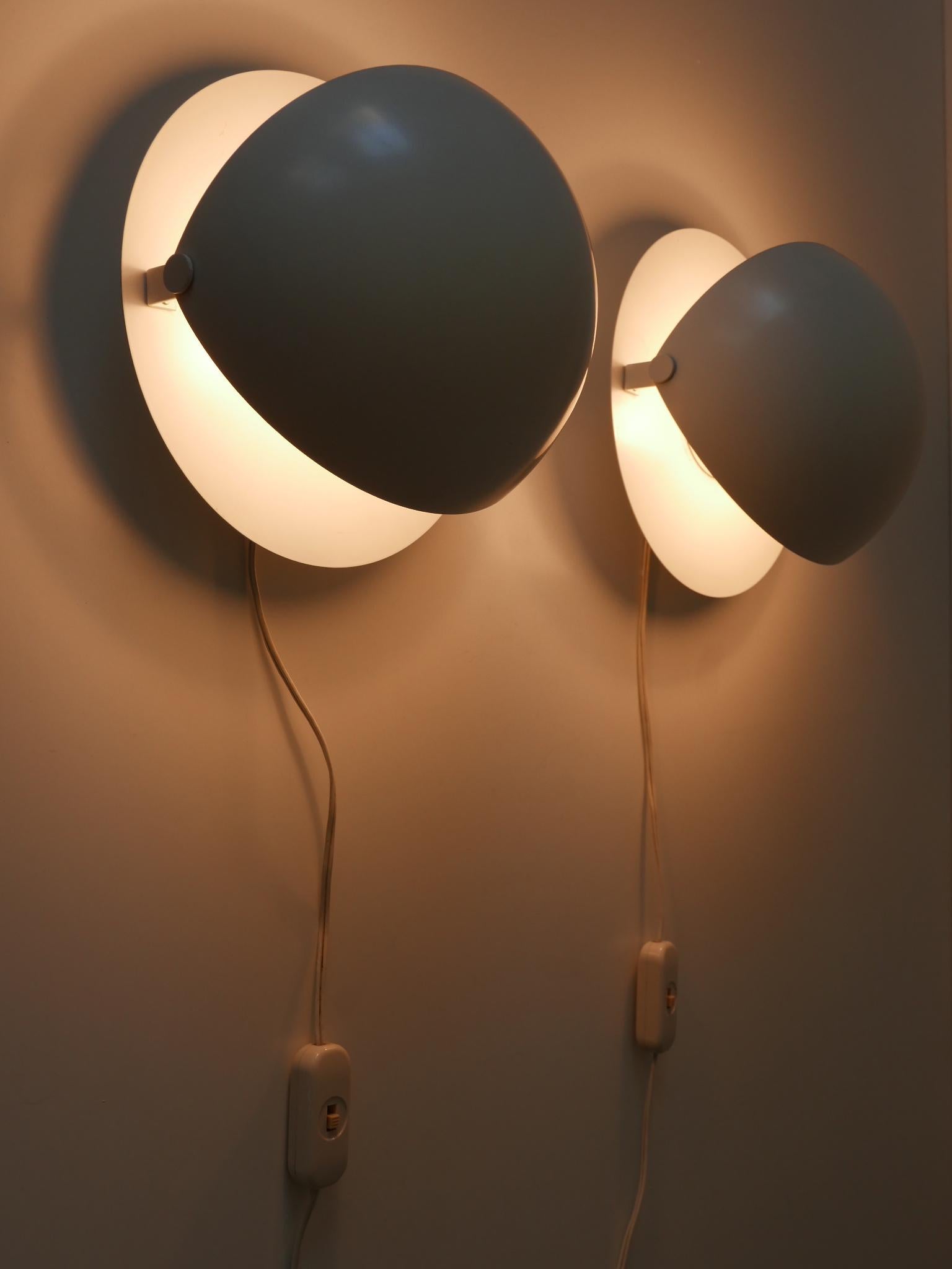 Set of two rare & elegant Mid-Century Modern sconces or wall fixtures. With adjustable reflectors. Designed & manufactured in Germany, 1960s.

Executed in white painted sheet metal, each fixture comes with 1 x E27 / E26 Edison screw fit bulb socket,