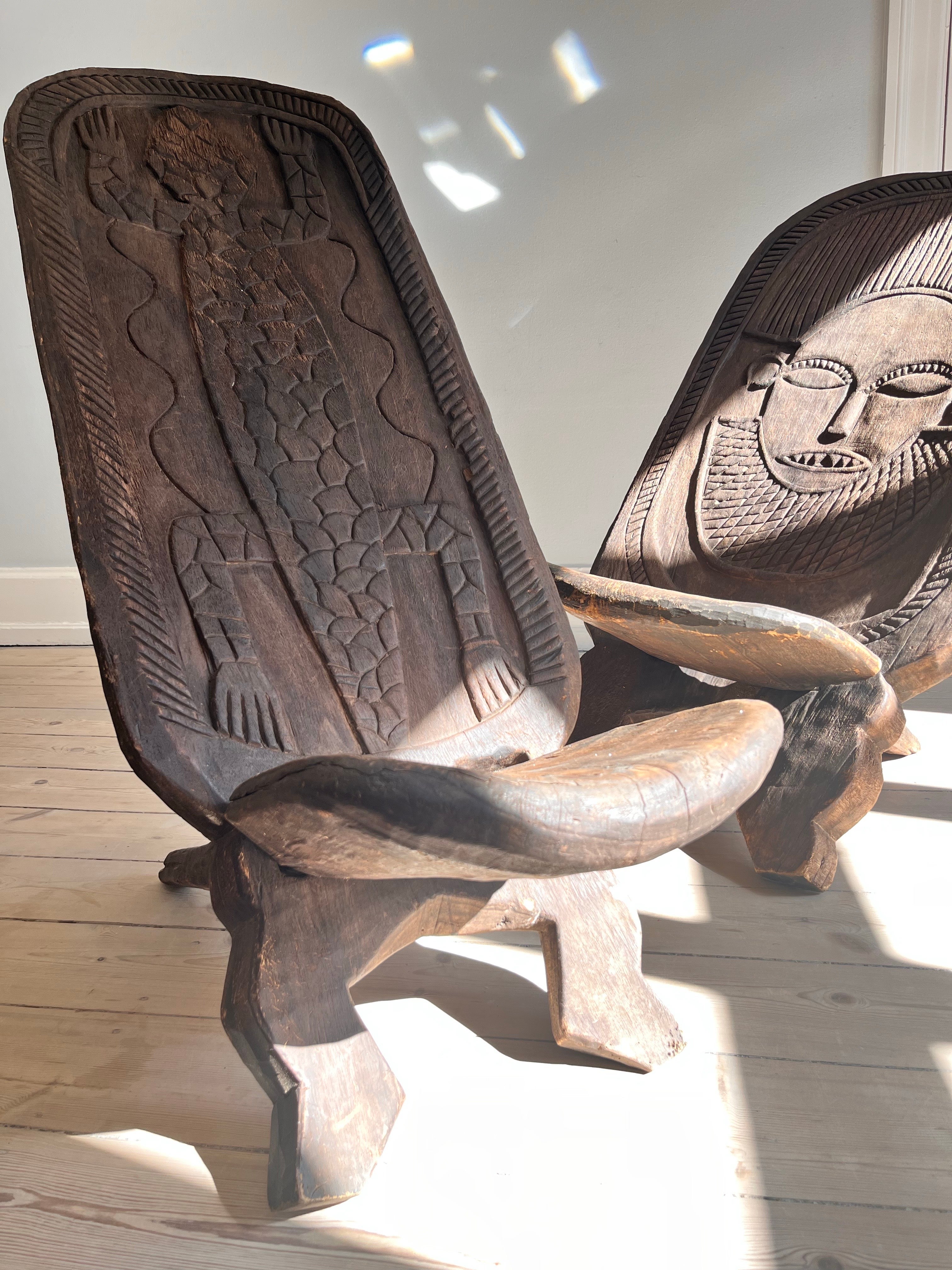These chairs are brought to Denmark from Africa - more specific Cameroon or South eastern nigeria.

Both chairs have decorative carved embellishments - a lizard and a woman. 

the chairs are assembled by putting the legs together with the top - easy