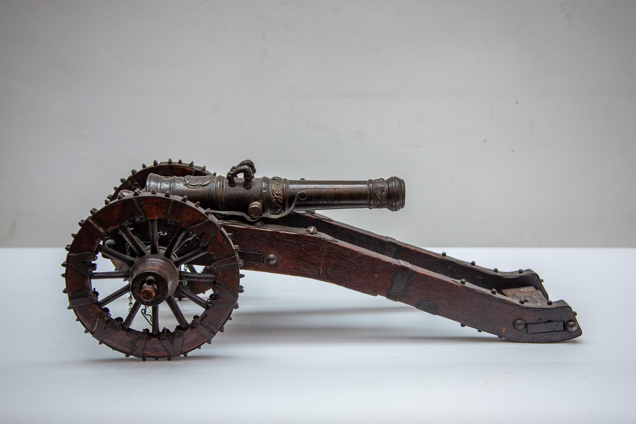 Antique set of 2 bronze Canons with engravings: AG and HV. 17th Century coat of Arms dated 1653. Miniature cannons were constructed by gun founders in order to advertise their abilities to buyers of real ones. Some were - like these - used by