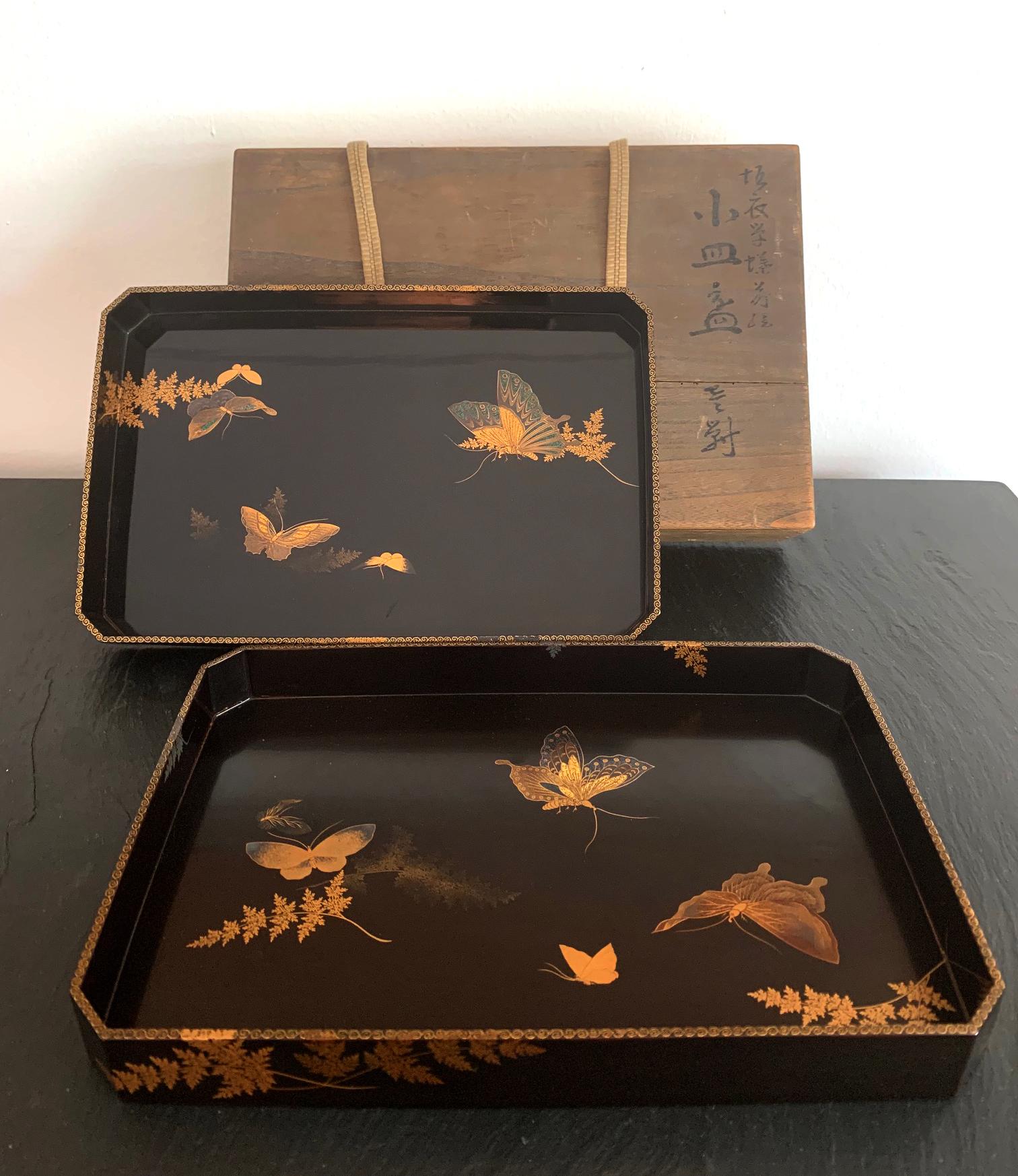 A set of two Japanese lacquer trays in gradual fitting size, circa 1850s-1960s late Edo period. The trays were superbly decorated with butterflies flying among autumn grasses, using both Hiramaki-e and Togidashi maki-e techniques to create a