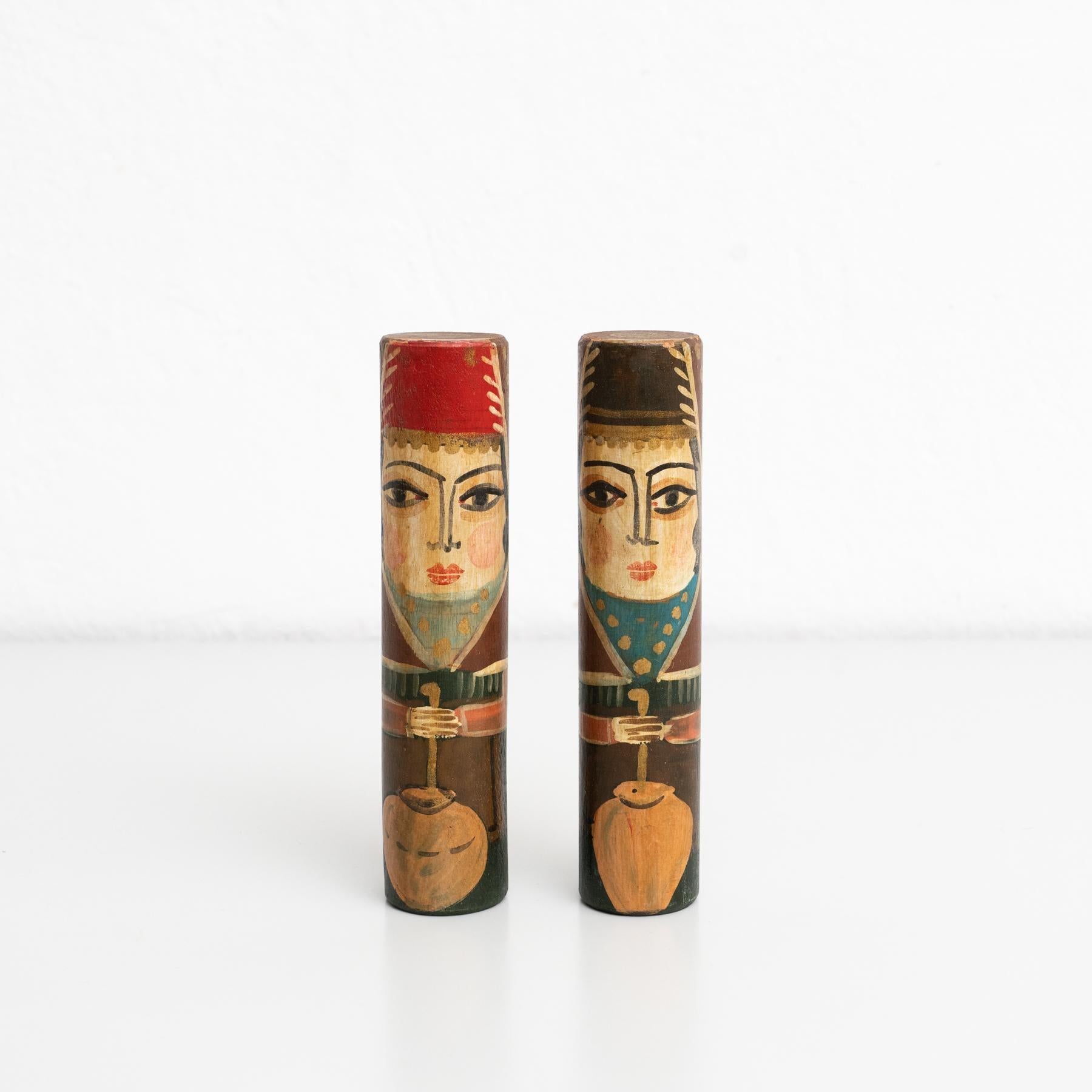 Set of two hand-painted antique figures of two men made of wood.  Explore the captivating charm of these two hand-painted antique wooden stick figures, depicting two men in traditional Middle Eastern attire. Crafted by an unknown manufacturer in