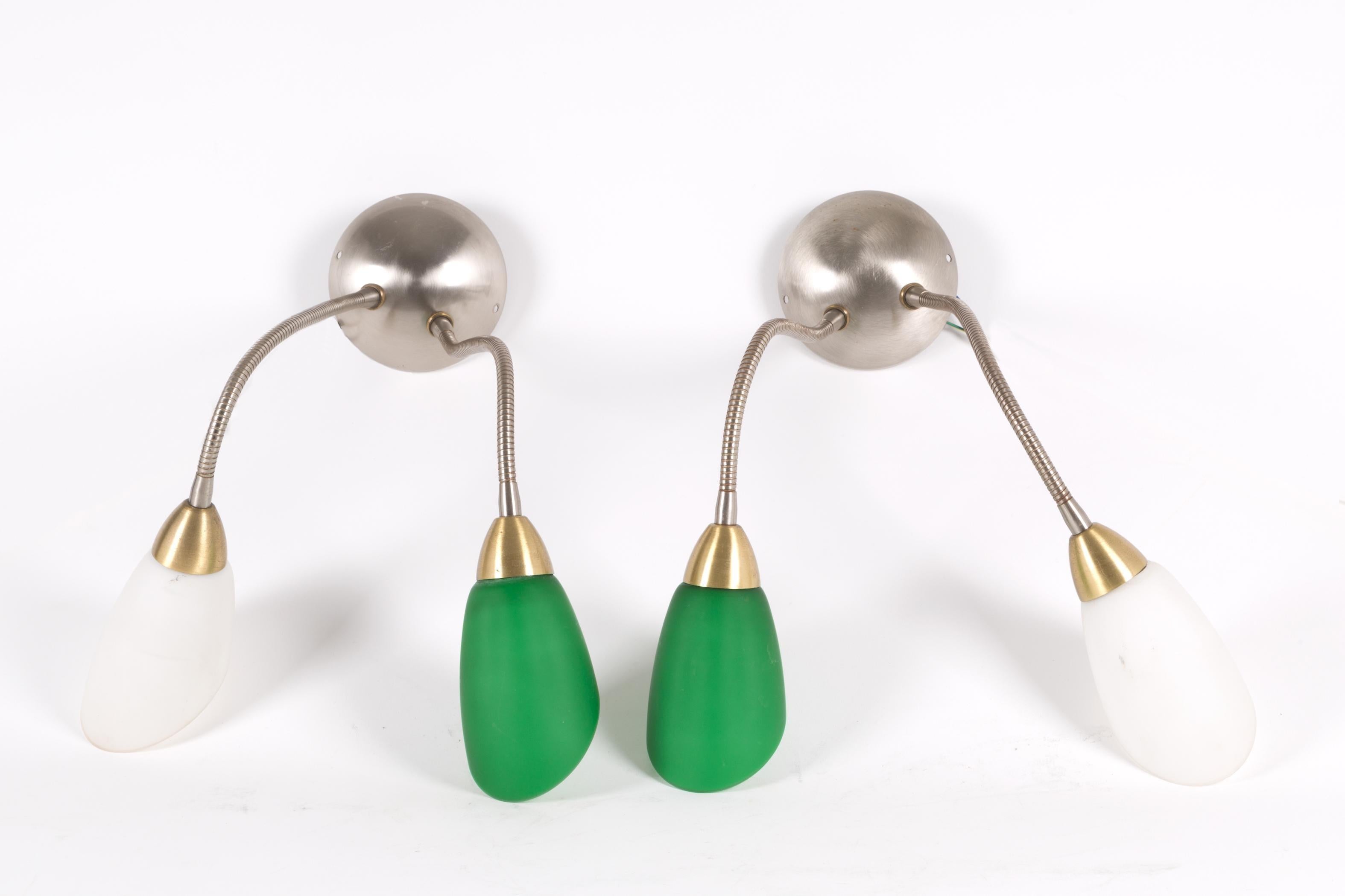 A set composed of two appliques and one wall lamp in metal and colored glass, Italian Manufacture, 1960s.
Measurements: 18 x 90 cm (chandelier) 12 x 52 cm (appliques).