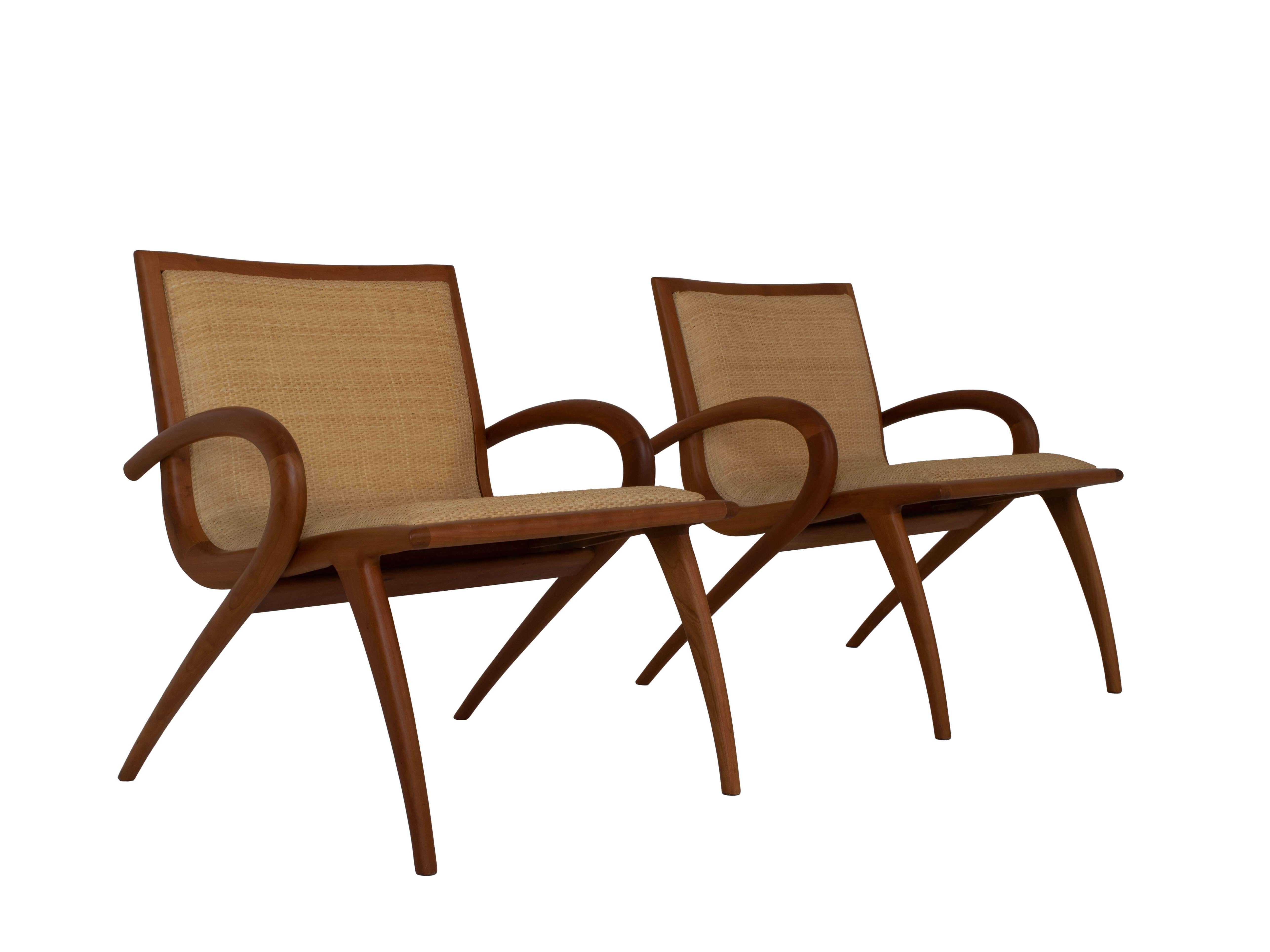 Amazing Set of two arm chairs by John Louis Graz, designed in Brazil 1950s. These organically shaped easy chairs are made of cherry wood and have padded wickerwork. The round shapes of the arm rests and legs make this an elegant and streamlined