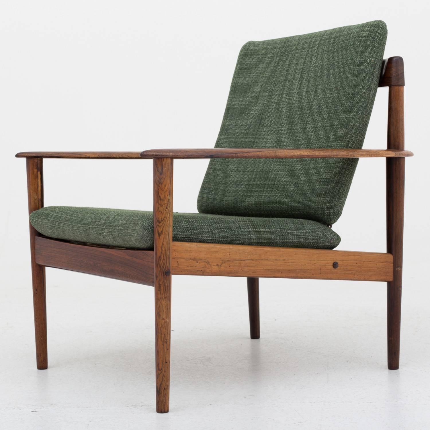 Two armchairs by Grete Jalk in rosewood with green cushions. Maker P. Jeppesen.