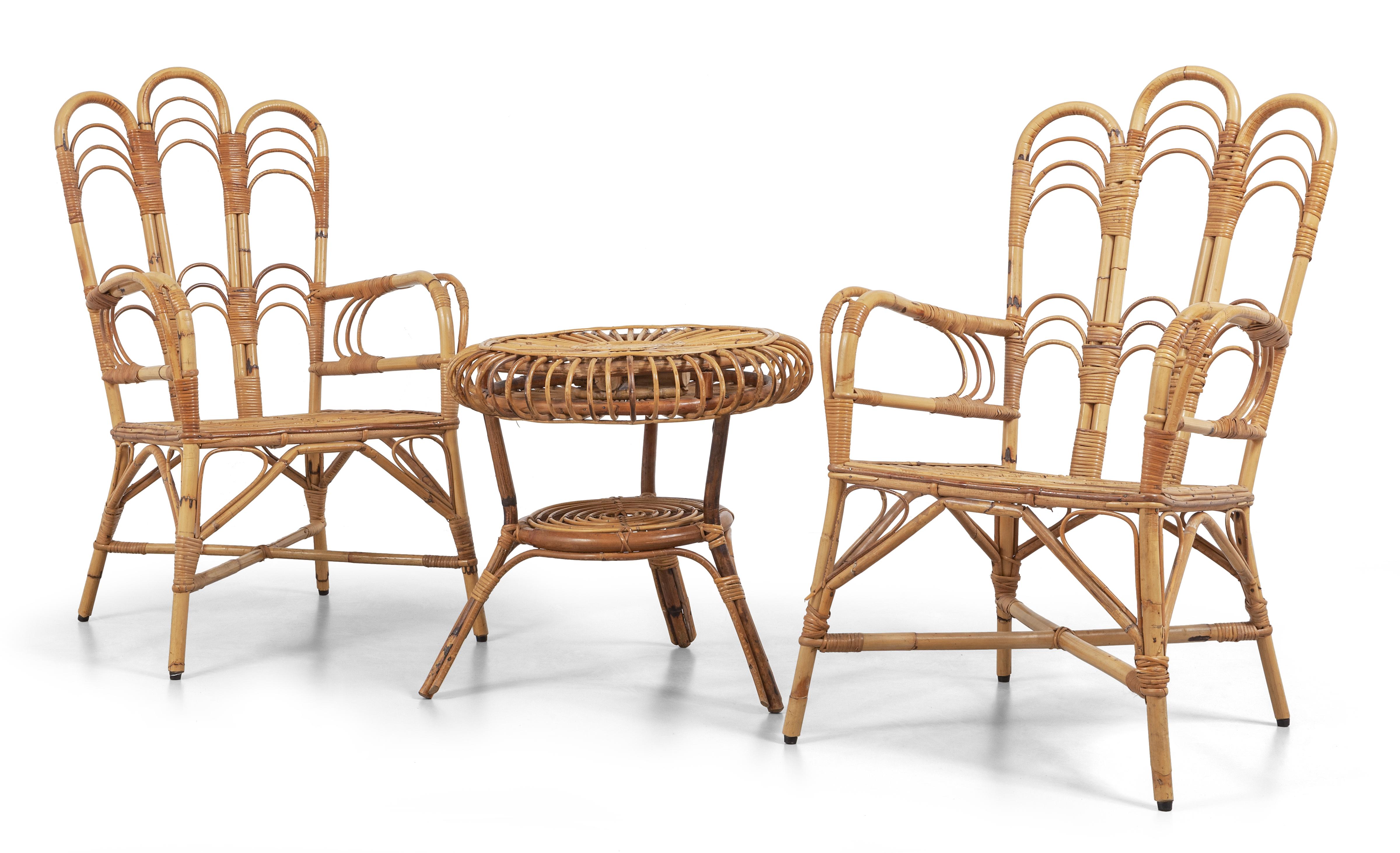 Elegant set of two armchairs and a round coffee table in rattan and bamboo. 

Made in Italy in the 1960s. 

Dimensions: 
- Armachairs: 100 cm height, 42 cm seated height, 60cm width, 65cm depth. 
- Table: 57 cm height, 60 cm diameter.