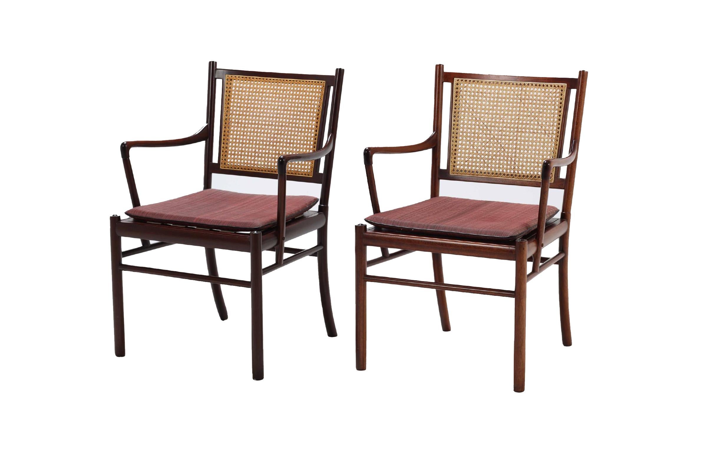 Pair of ‘Colonial’ armchairs, model PJ301 in mahogany, cane and original fabric. Elegant pair easy chairs with a mahogany slim frame by the Danish designer Ole Wanscher. These chairs show the great craftsmanship and attention to detail that Ole