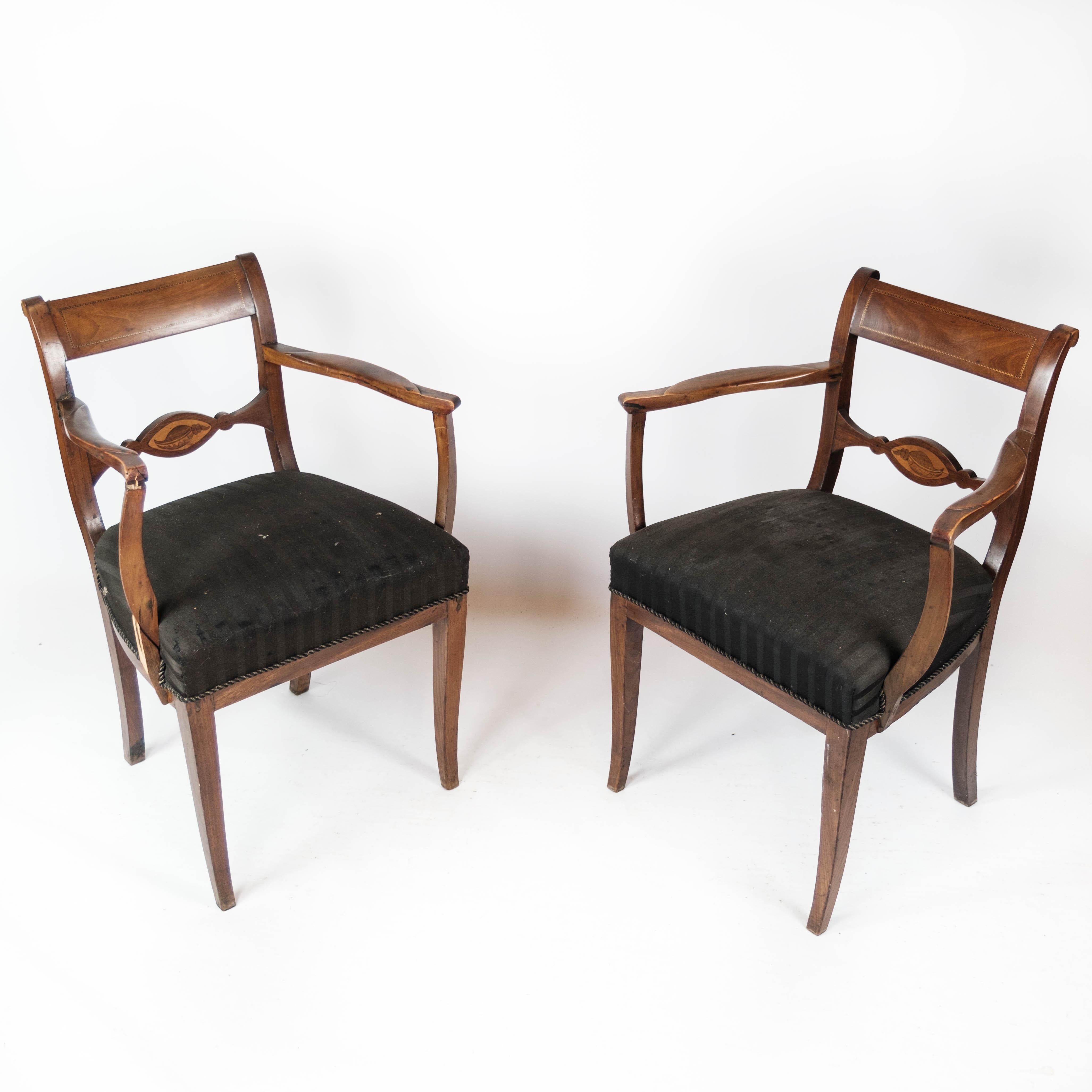 These two mahogany armchairs, upholstered in sleek black fabric, date back to the elegant era of the 1860s. Their timeless design and classic upholstery make them a sophisticated addition to any interior.

Despite their age, these chairs are in good