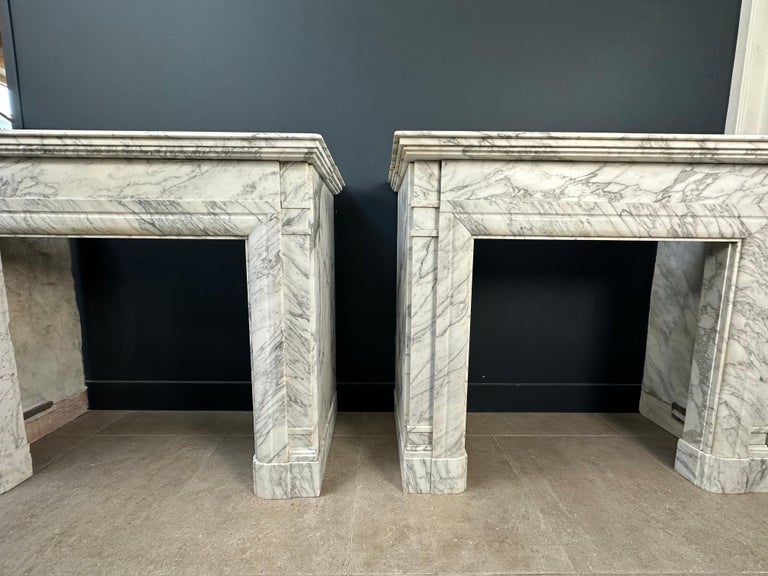 A beautiful set of two white marble antique mantelpieces. This set comes from a beautiful mansion in the center of Amsterdam just behind the municipal museum. The set adorned the front and back room. The Art Deco style of these antique fireplaces