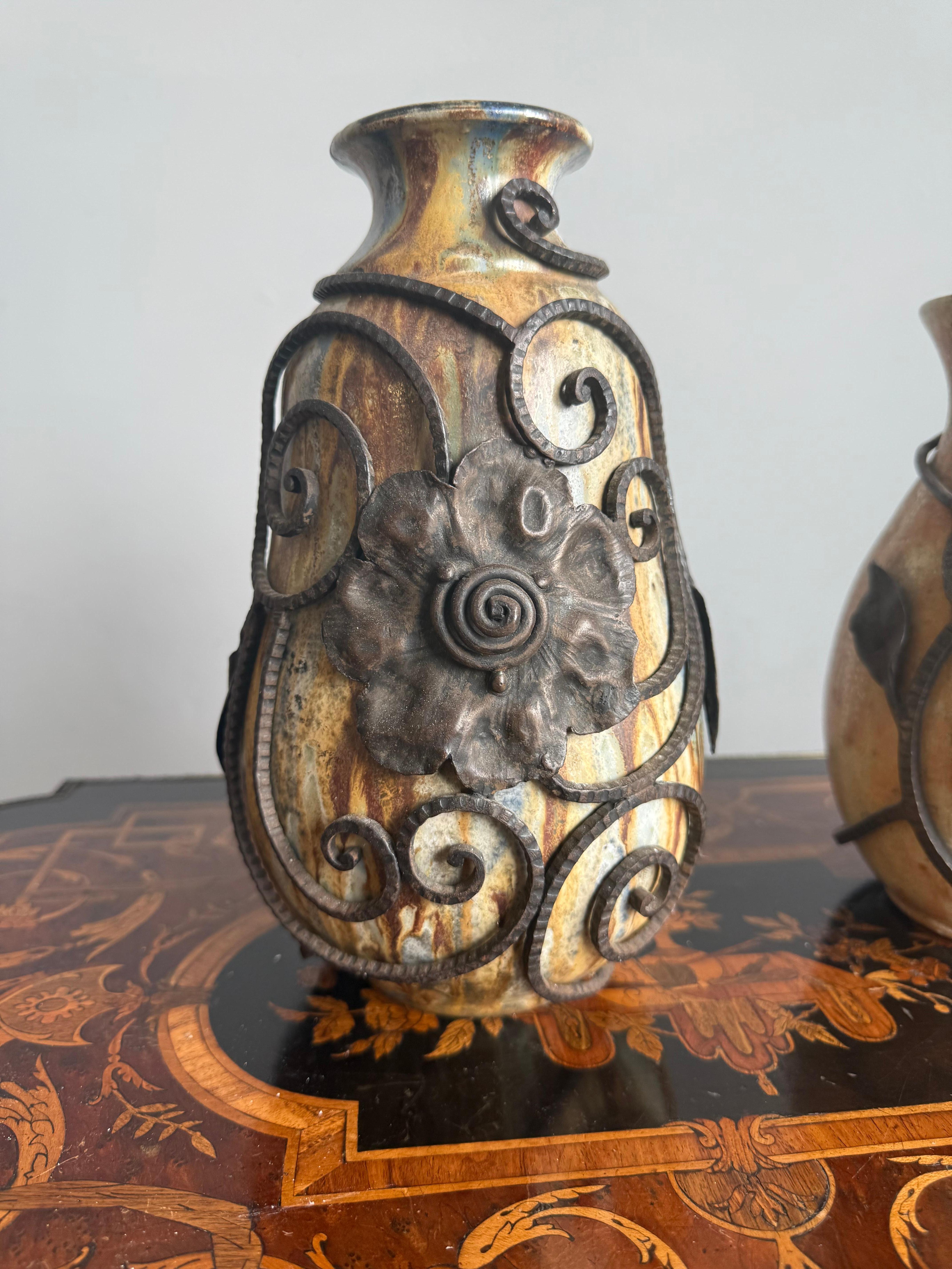 Set of Two Art Deco Ceramic Vases by Roger Guérin with Wrought Iron Floral Work by F. Carion, Belgium, circa 1925.

An exquisite and rare matched pair of Art Deco vases by renowned Belgian ceramist Roger Guérin, adorned with intricate wrought iron