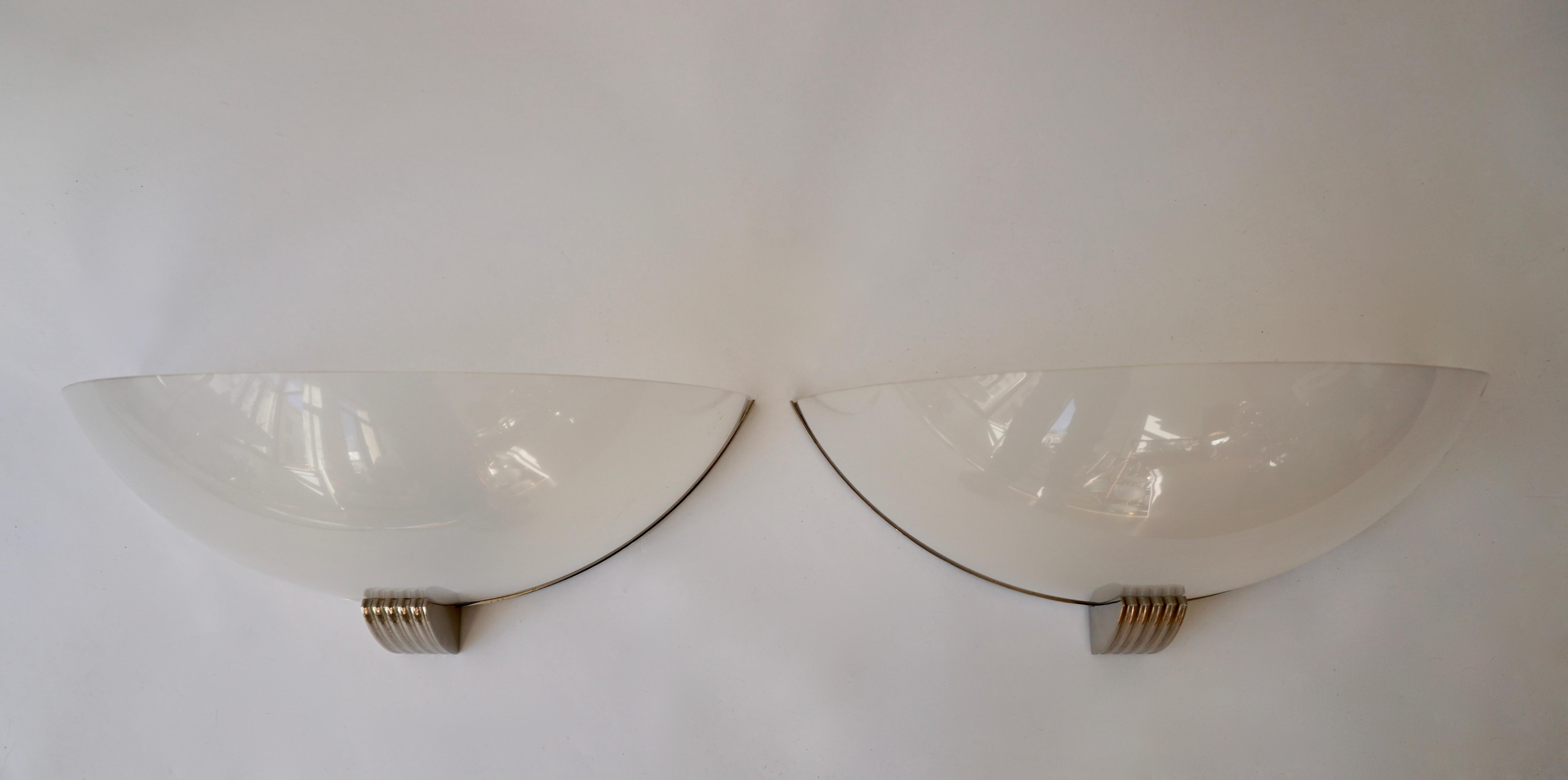 Set of two elegant Art Deco wall lamps or sconces. Manufactured in the 1920s and executed in polished metal en plastic.
Each lamp needs two x E14 Edison screw fit bulbs.
Dimensions:
Width 51 cm.
Height 21 cm.
Depth 26 cm.