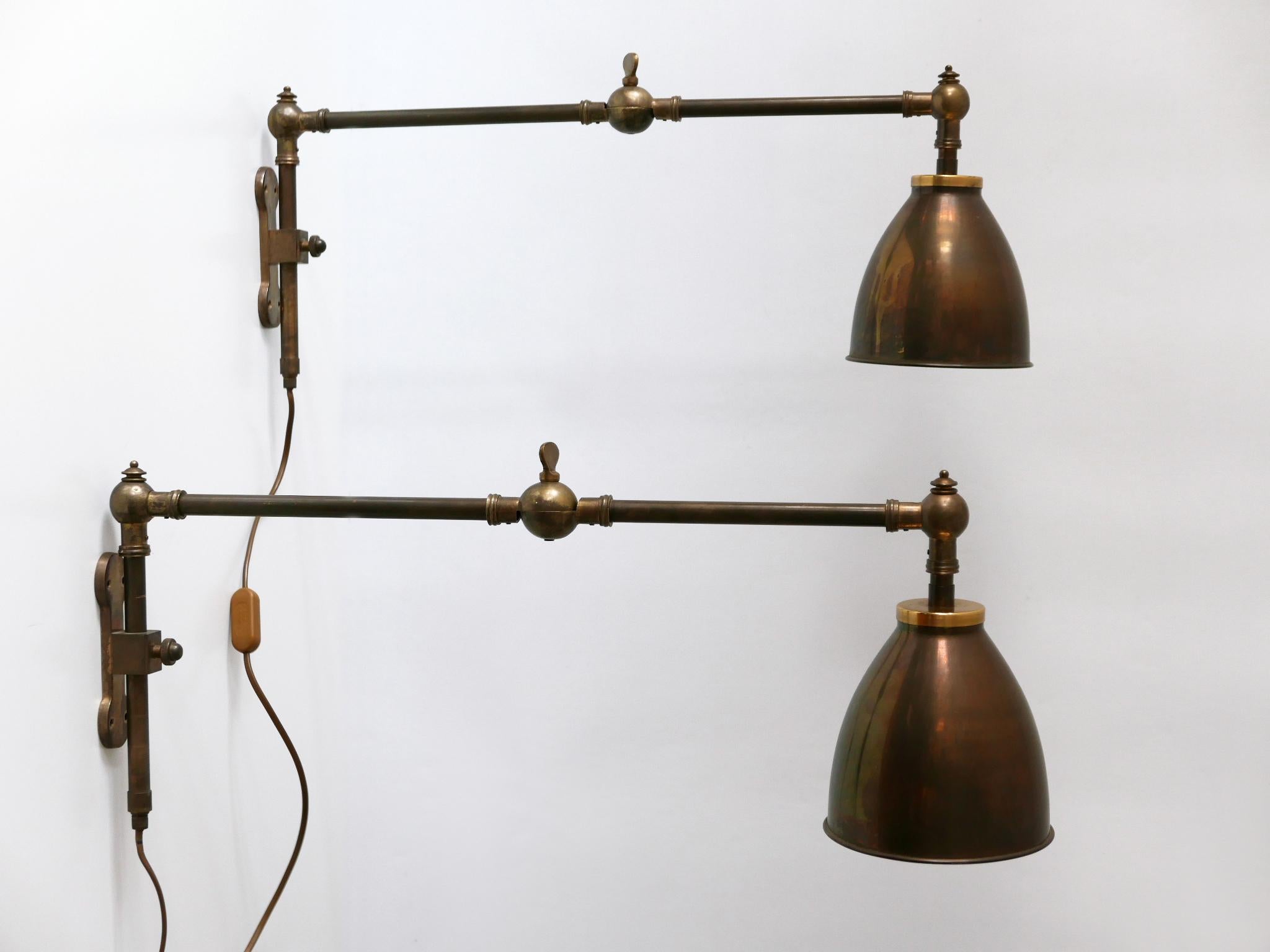 Set of two elegant Mid Century Modern swing brass wall lamps or reading lights. Designed and manufactured in Germany, 1970s.

Adjustable height and arm. Interrupter on the cord.

Executed in bronze patinated brass, each lamp needs 1 x E27 / E26